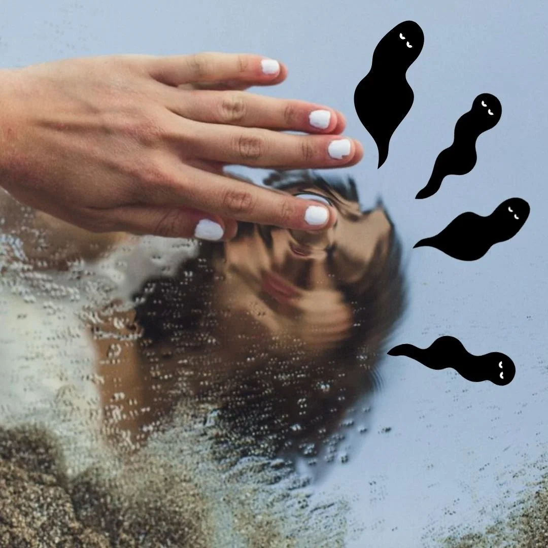 Woman touching reflection of herself in water with Our Kind Therapy cartoon logo figures flying out 