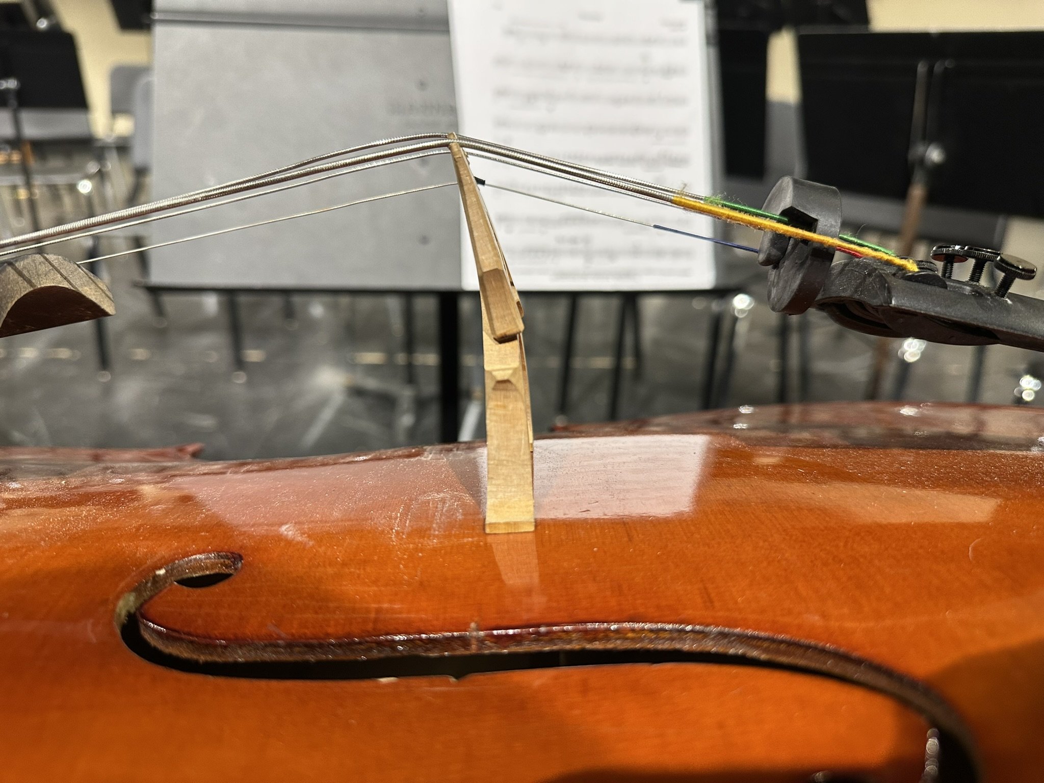 Warped cello bridge