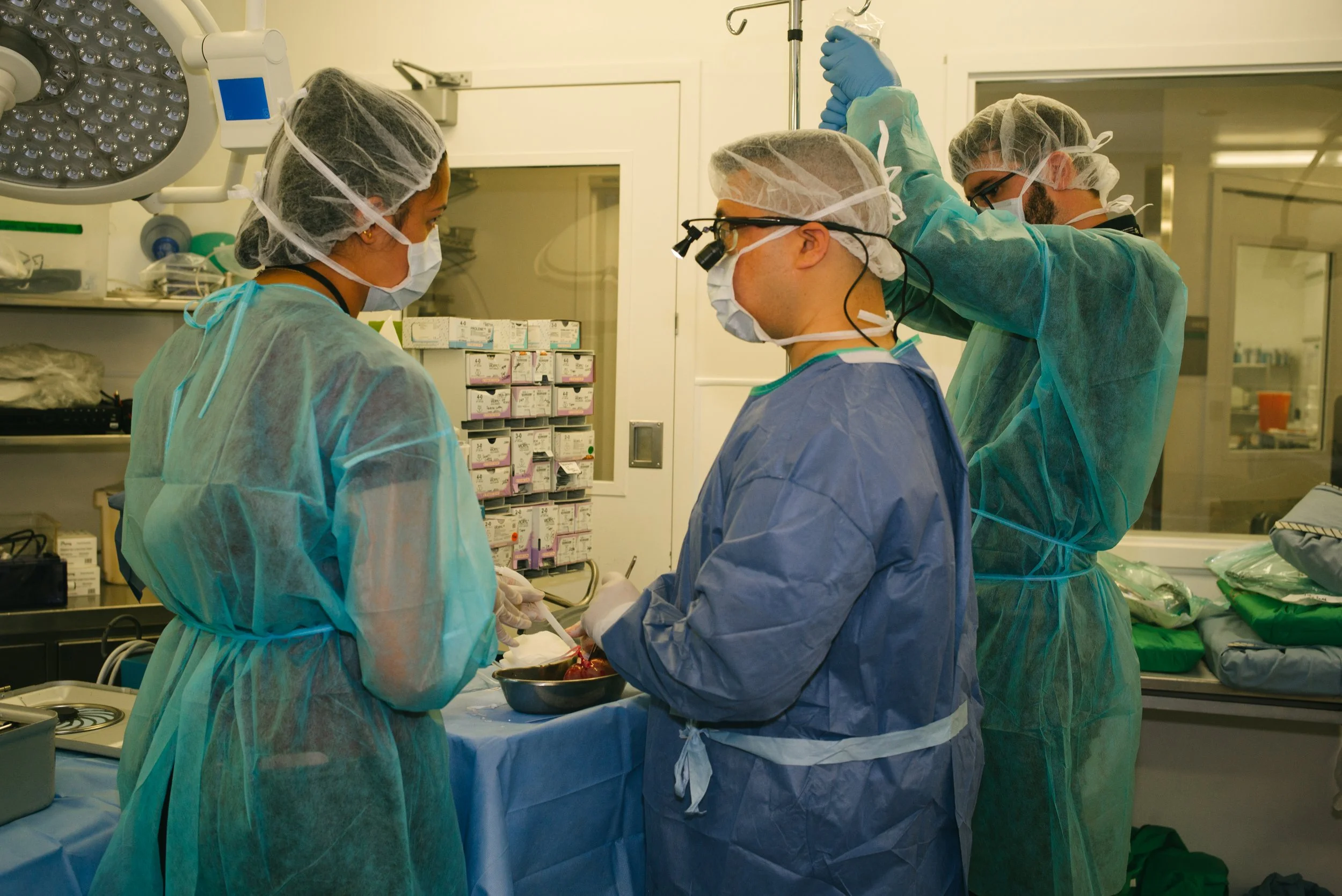 Medical team performing surgery in an operating room.