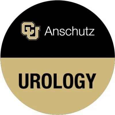 A circular logo with the top half black and the bottom half gold. In the top section, there is a beige logo with the letters 'CU' and the word 'Anschutz' next to it. In the bottom section, the word 'UROLOGY' is written in bold black letters.