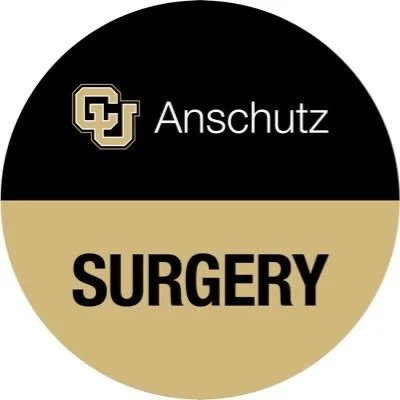 A circular logo with a black top half and a gold bottom half, featuring the text 'CU Anschutz SURGERY' in the center.