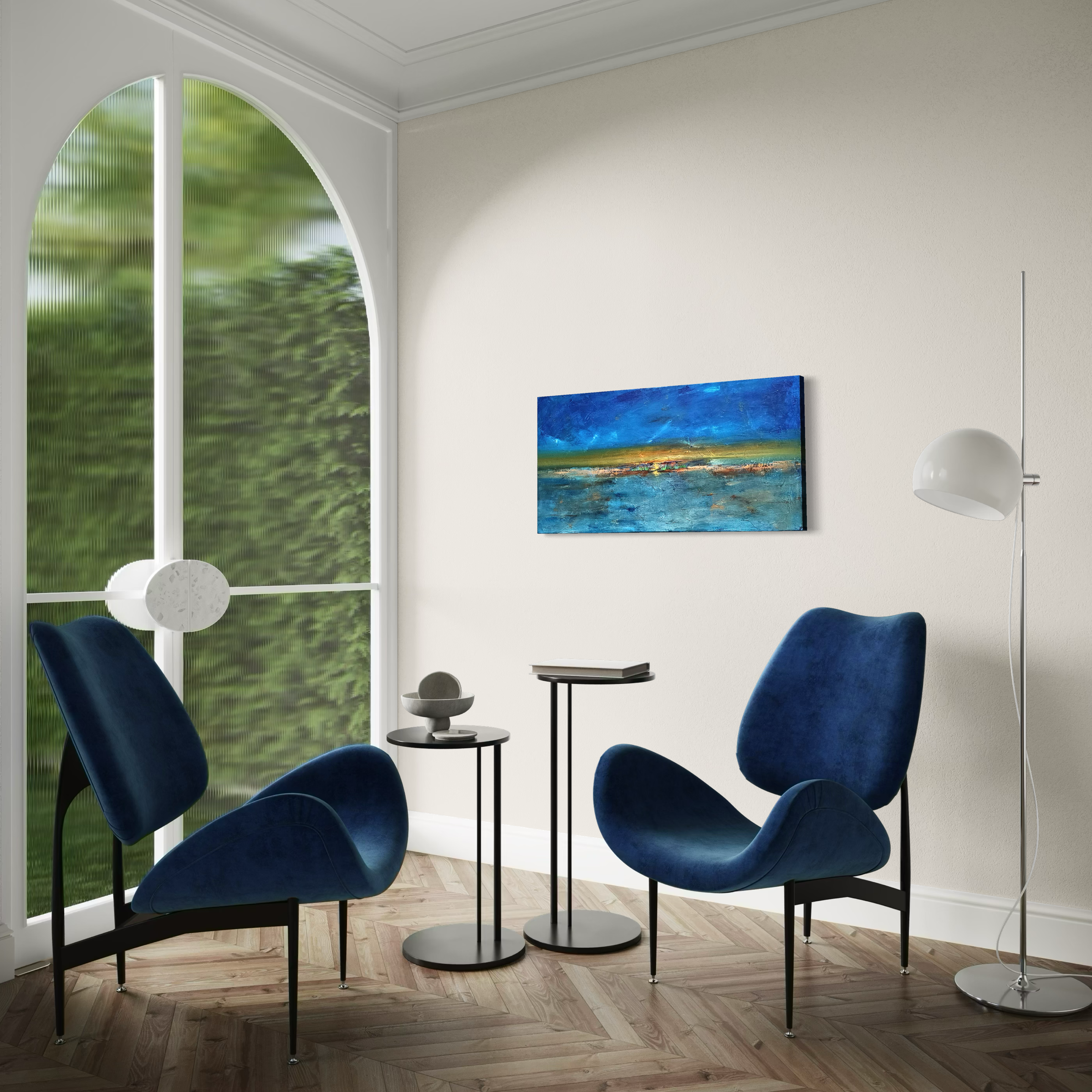Interior of a modern room with two blue velvet chairs, a black round side table, a floor lamp, and a landscape painting on a white wall, near a large arched window with greenery outside.