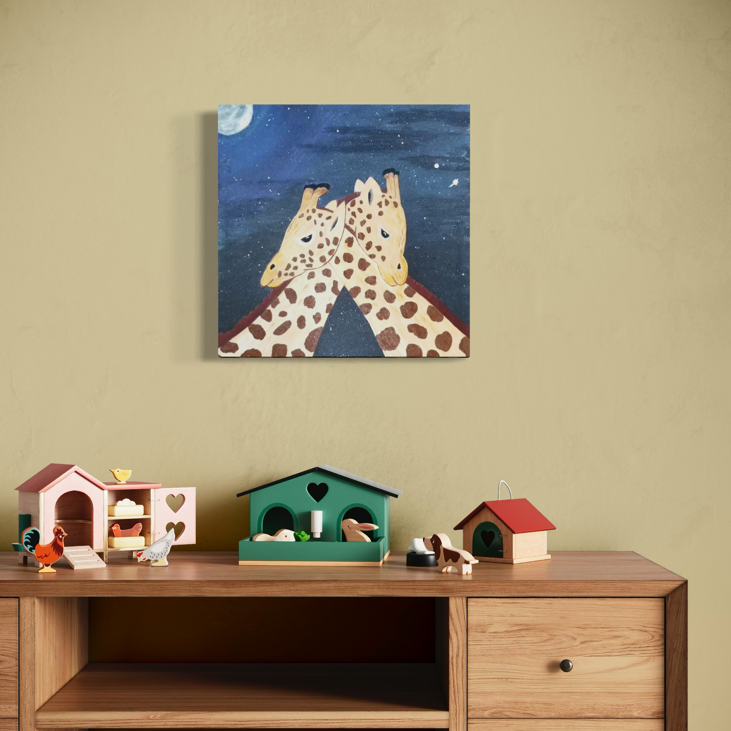 A wall with a painting of two giraffes touching heads, night scene with full moon and stars, above a wooden table with colorful toy animal houses and figurines.