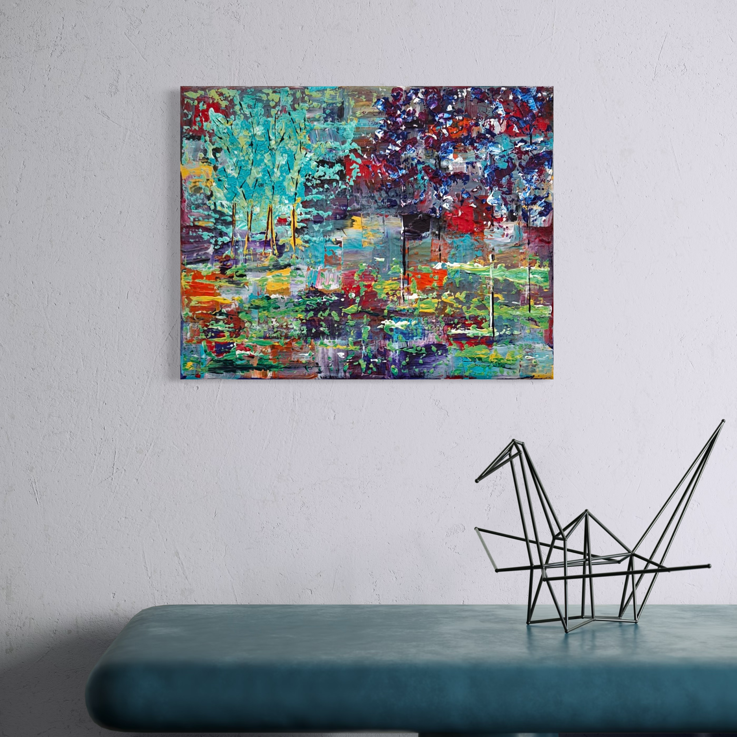 Colorful abstract landscape painting on white wall, metal geometric sculpture on turquoise bench.