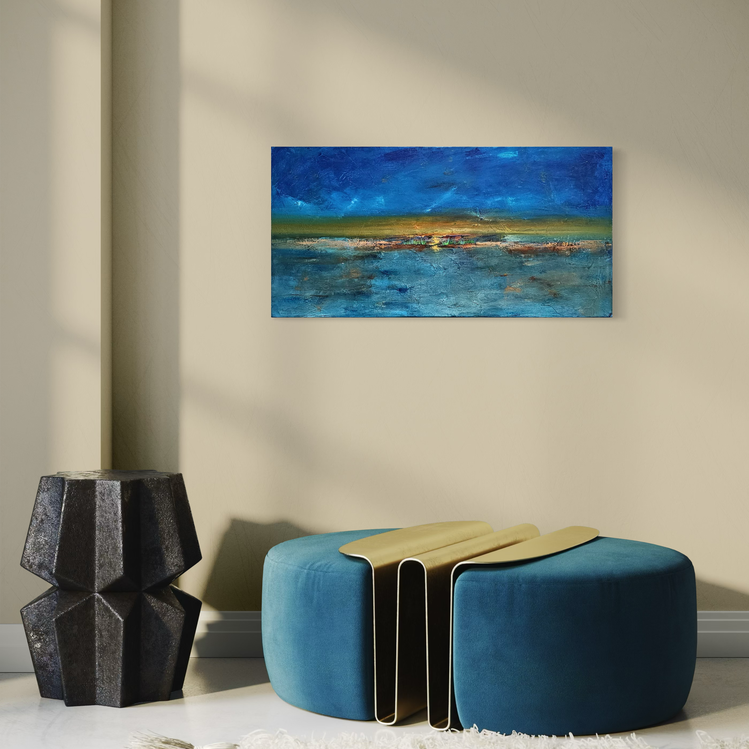 A modern interior with a blue ottoman, a black geometric side table, a yellow folding chair, and a landscape painting hanging on a cream wall.