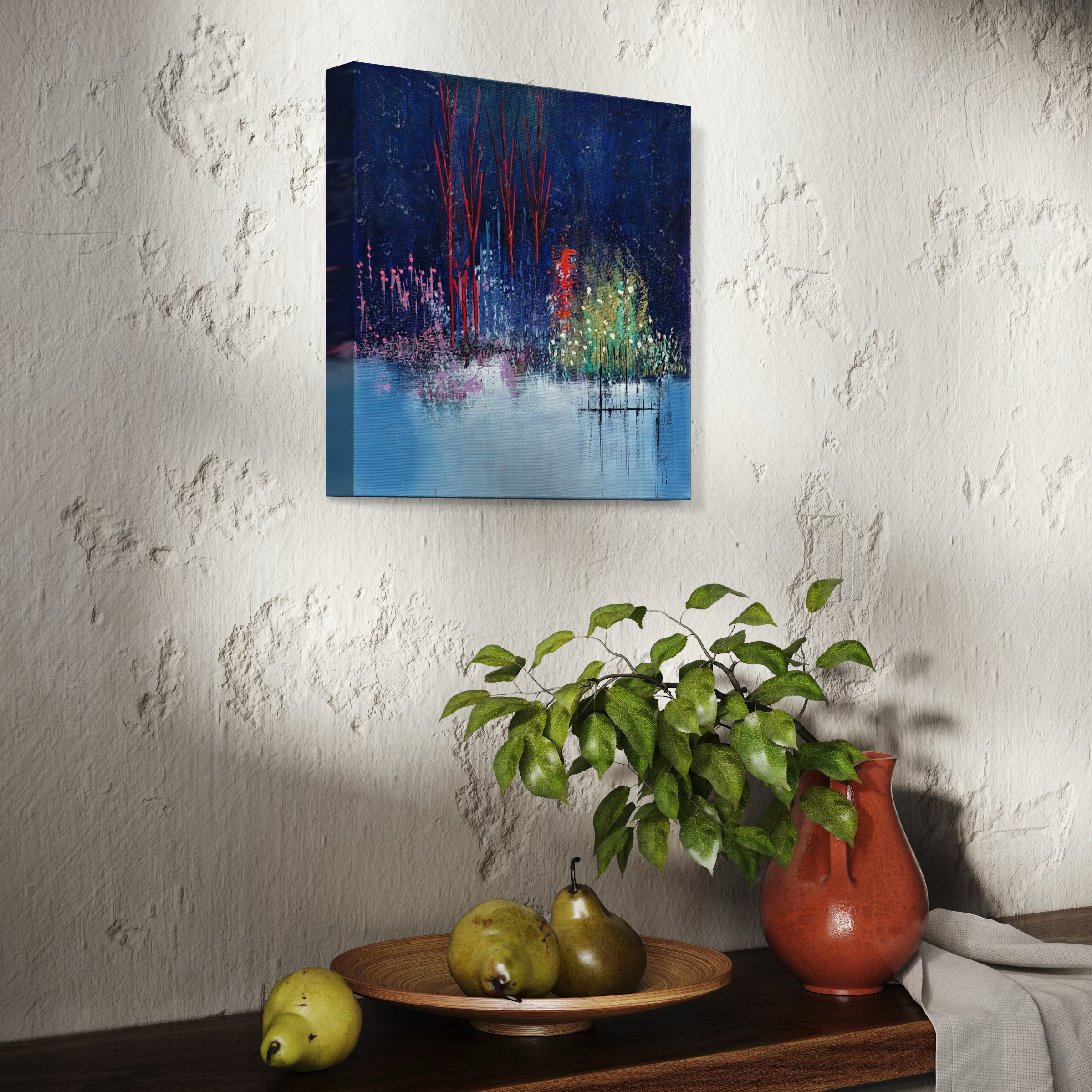 A still life interior scene featuring a textured white wall with an abstract painting, a wooden table with a terracotta vase holding a green leafy plant, a wooden plate with three pears, and a white cloth draped over the edge of the table.