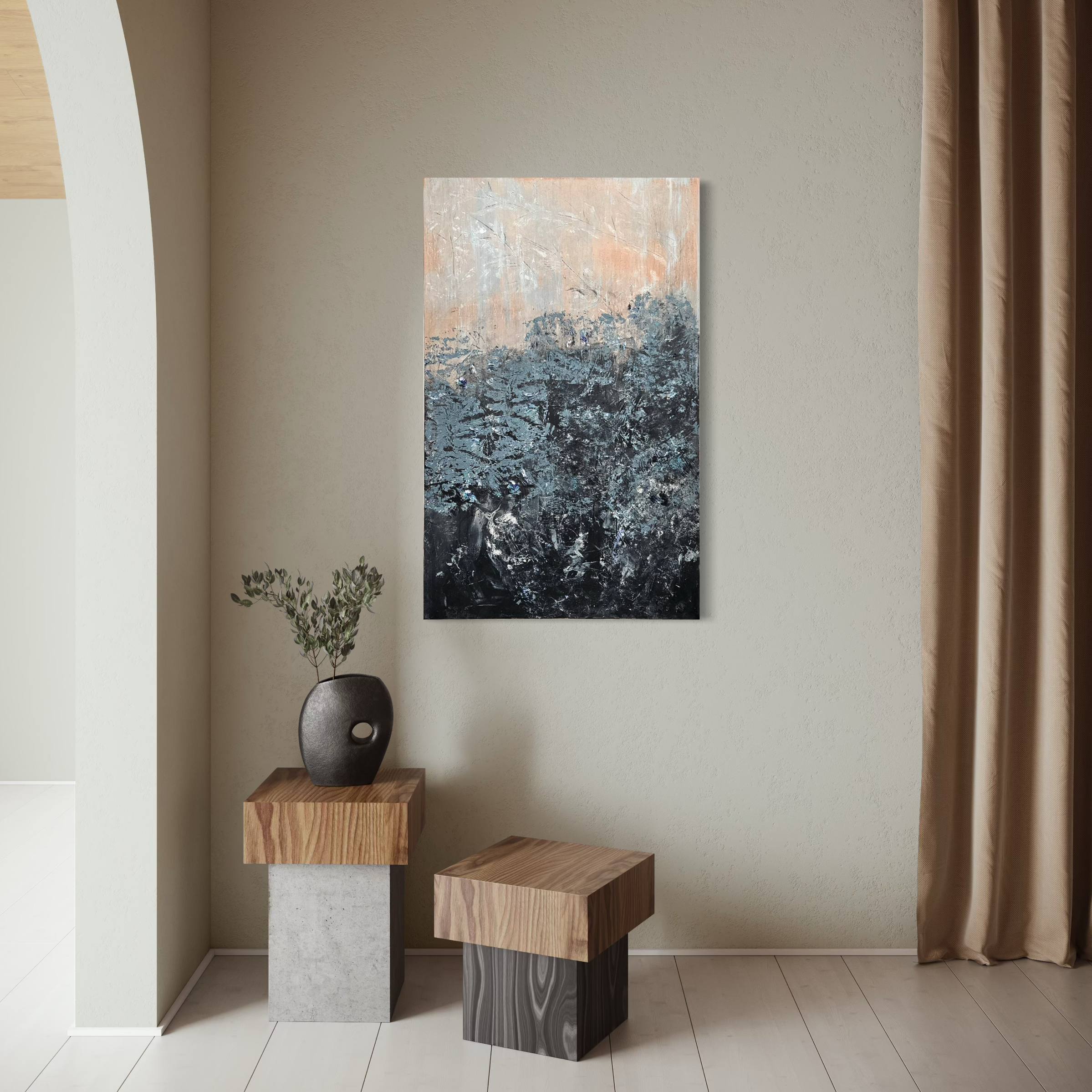Interior scene with a beige wall, a hanging abstract painting of trees in muted colors, a small wooden cube table, a taller concrete block supporting a round black vase with green foliage, a second smaller wooden table, and a beige curtain to the rig