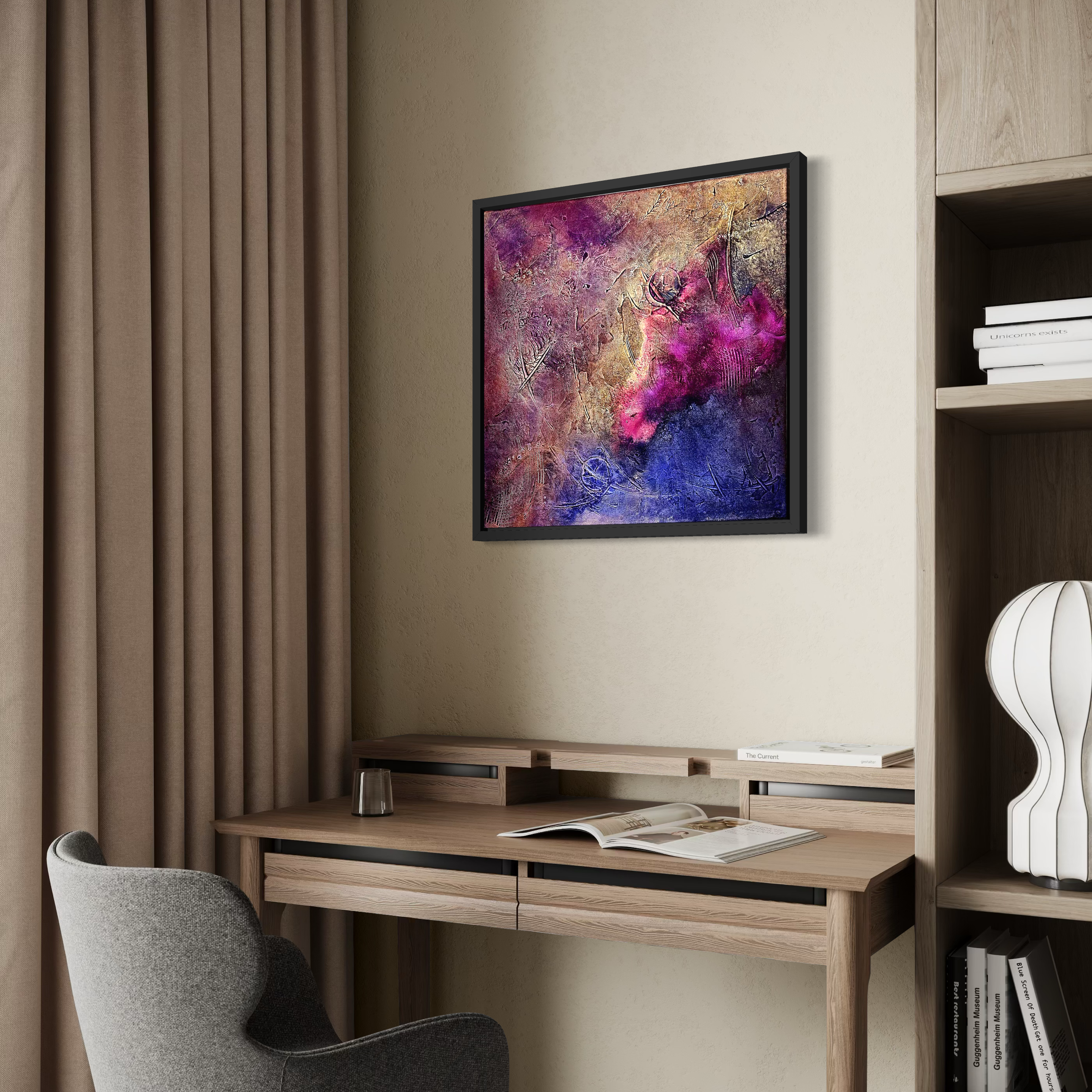 A modern interior space with a beige wall, a framed abstract painting, a wooden desk with books and a glass, and a gray upholstered chair. There are beige curtains on the left and a wooden bookshelf on the right with a white sculptural vase and books