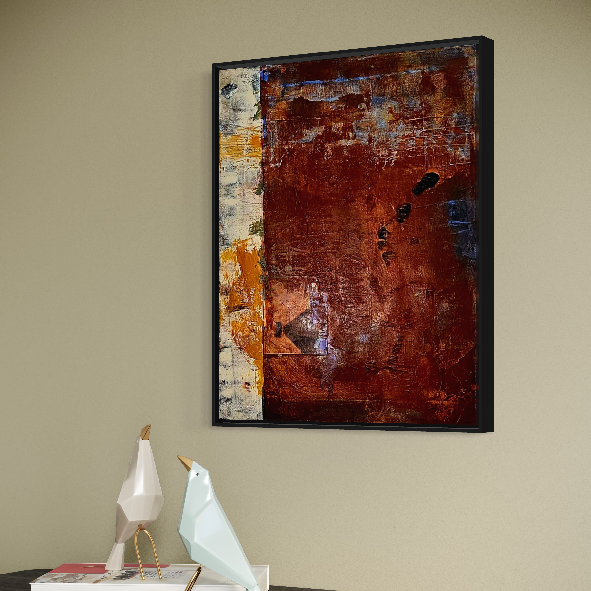 Abstract painting with red, orange, blue, and white textured layered colors hanging on a beige wall, with two decorative animal sculptures on a table below.