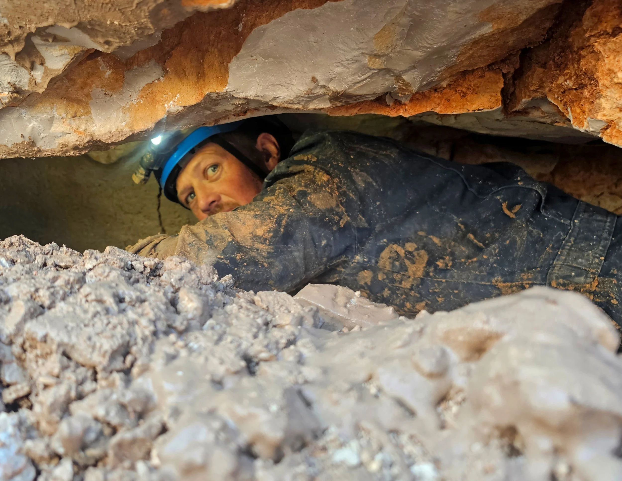 Crawling through a cave section with low head space