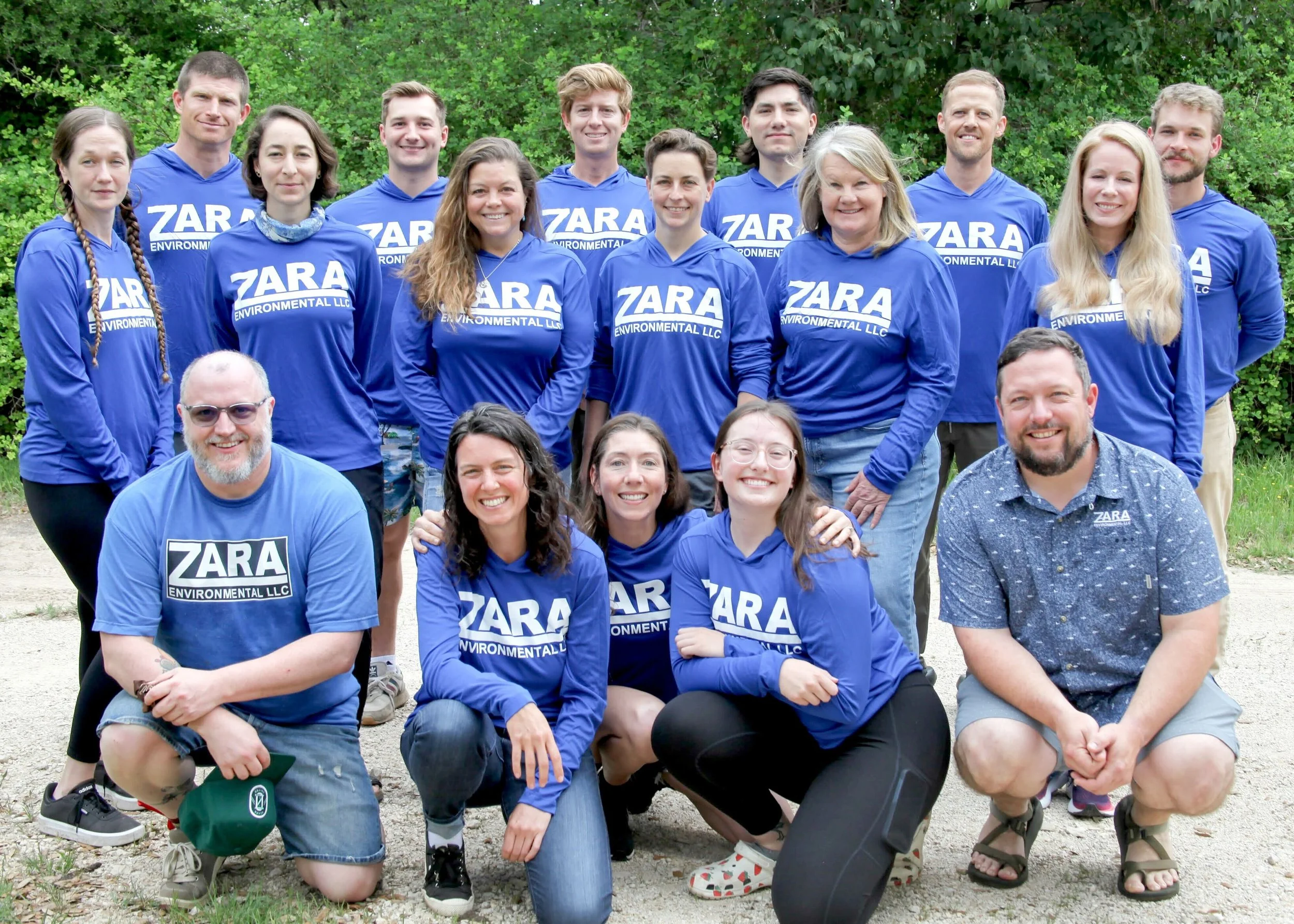 Group of people outdoors, wearing blue shirts with