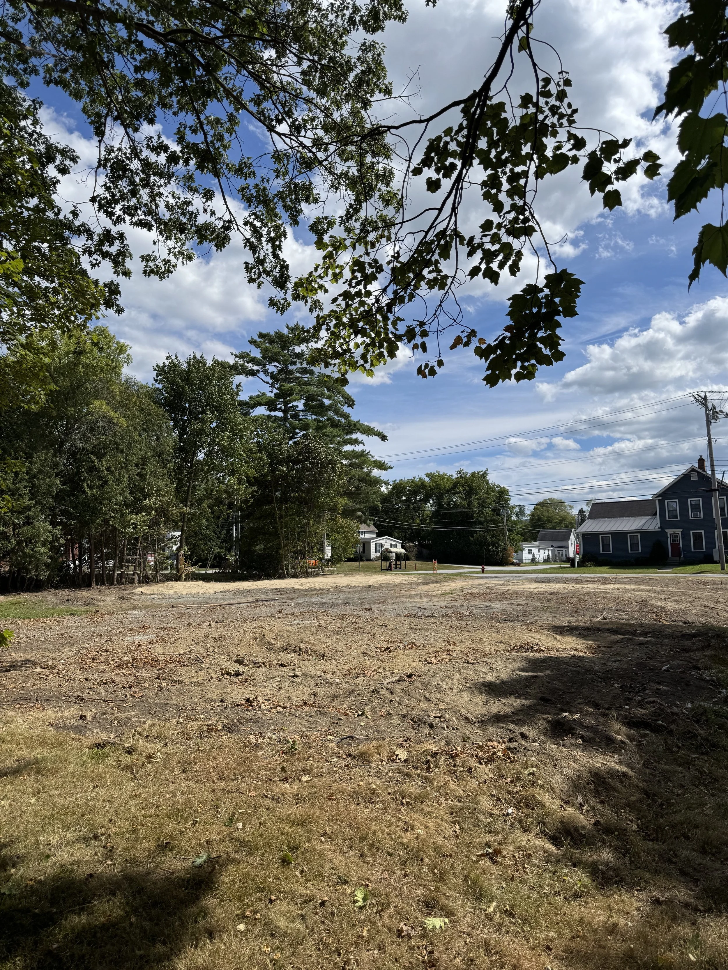 This is a post-demo photo of property that has had an old structure demolished, and the land leveled and cleared for a new build.