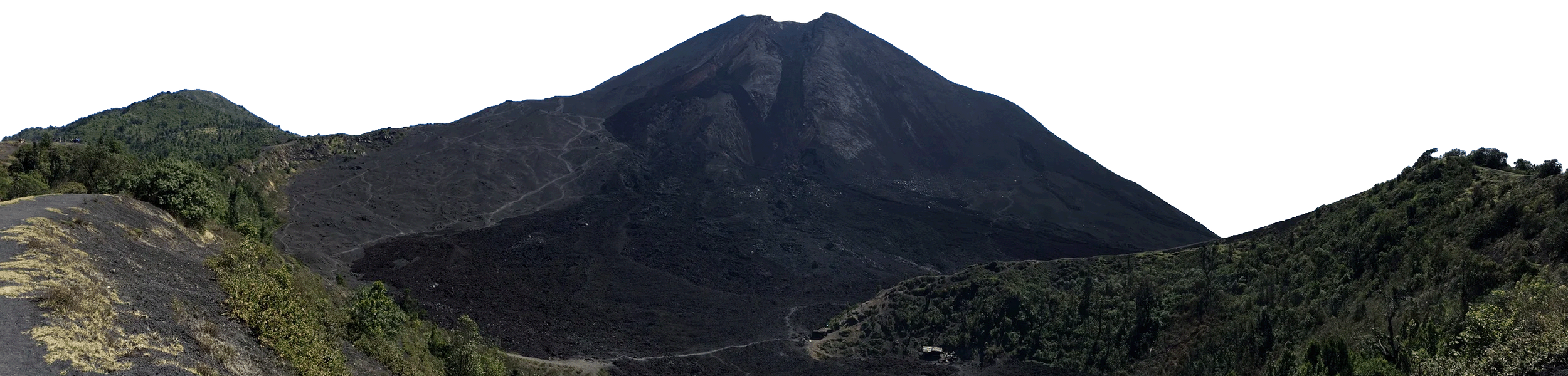 A large mountain with a dark, rocky, volcanic appearance, surrounded by green hills and vegetation.