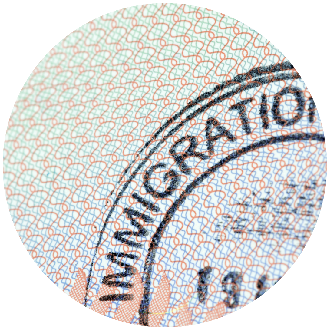 Close-up of a passport page with a stamp and intricate security background pattern.