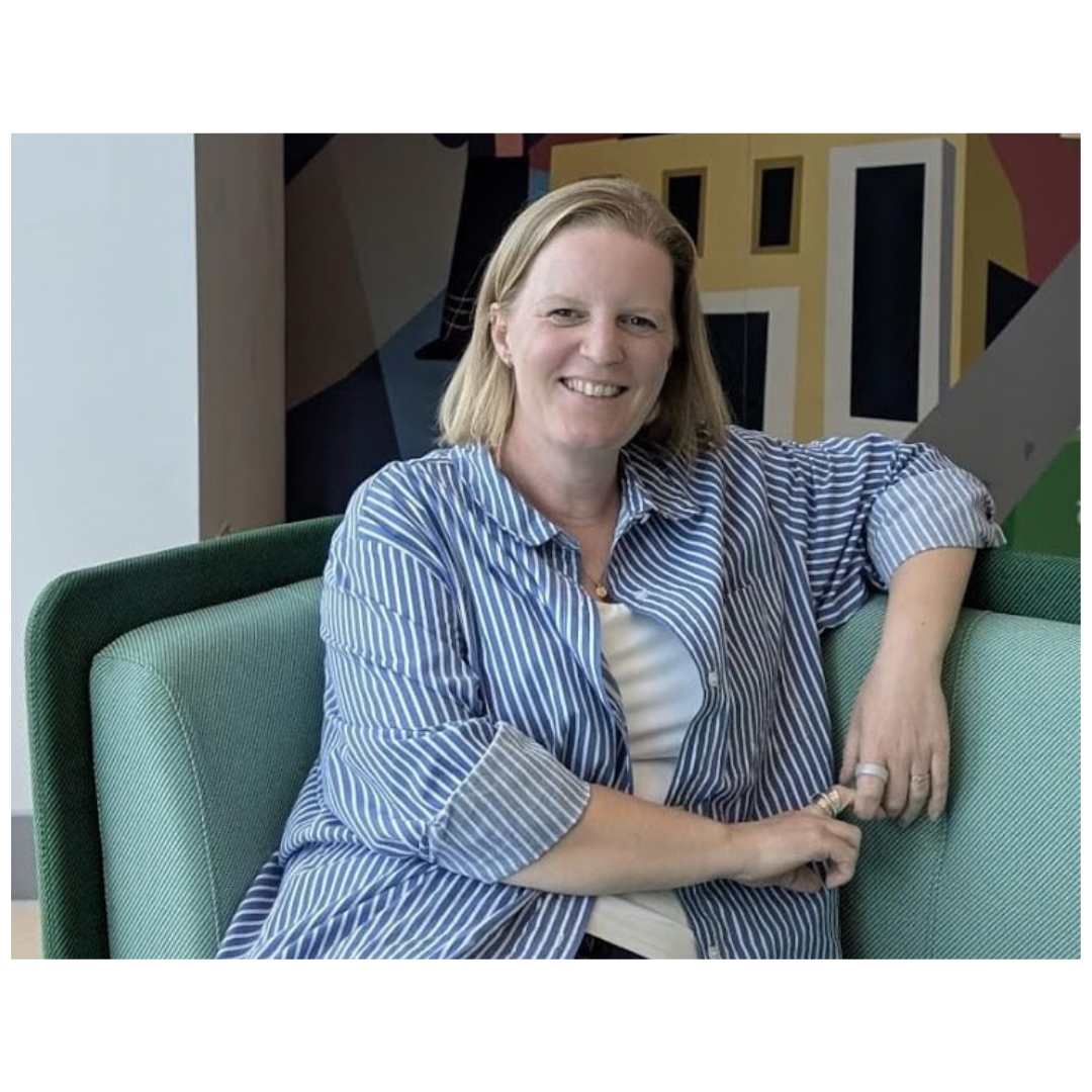 gemma sitting on a green sofa looking relaxed smiling