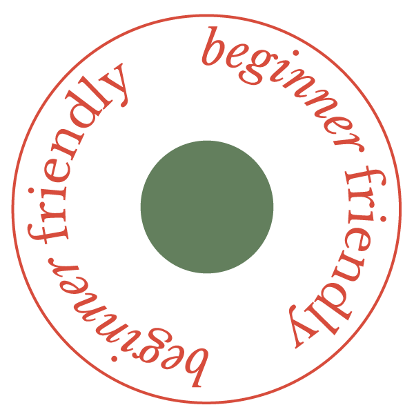 Circular sign with red text on a black background. The text reads 'beginner friendly' and 'beginners' arranged in a circle around a green dot in the center.