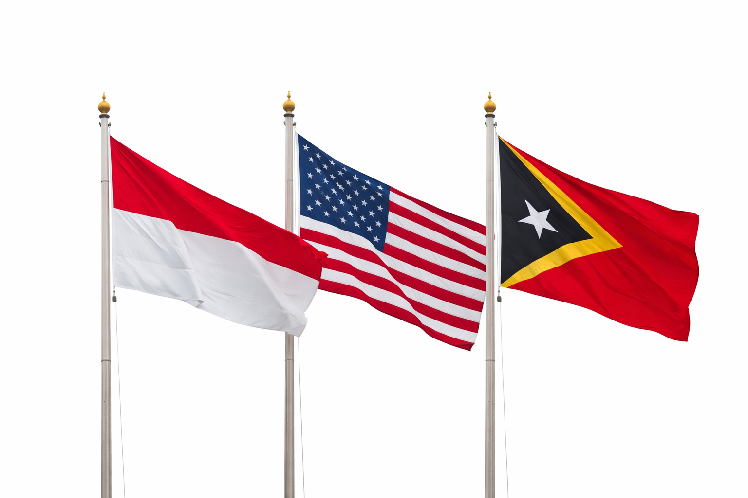 Three flags flying on poles against a white background: the flag of Indonesia, the flag of the United States, and the flag of Timor-Leste.