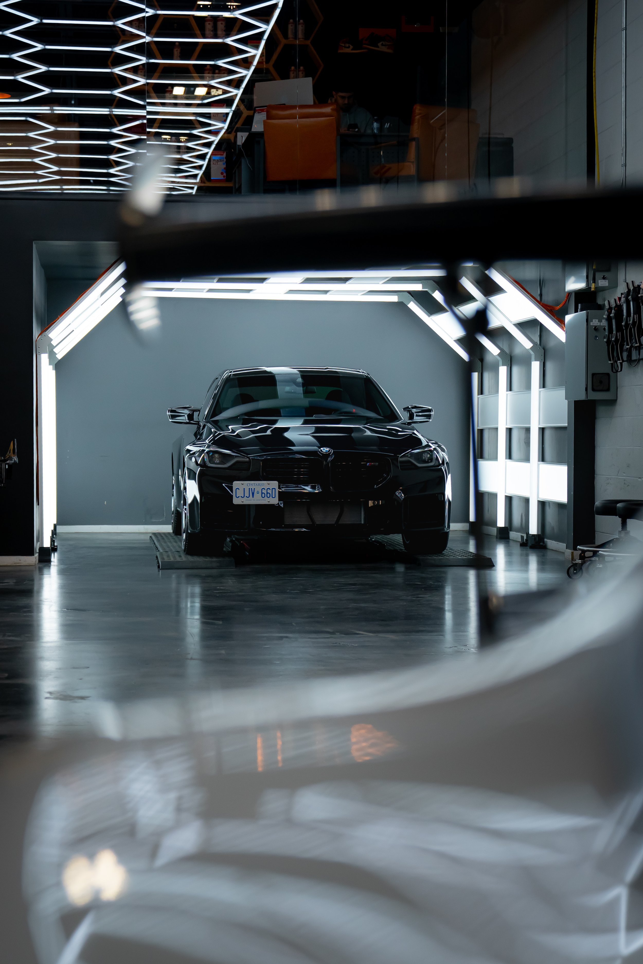BMW M2 curing inside ZAutoCare's dedicated ceramic coating light tunnel.