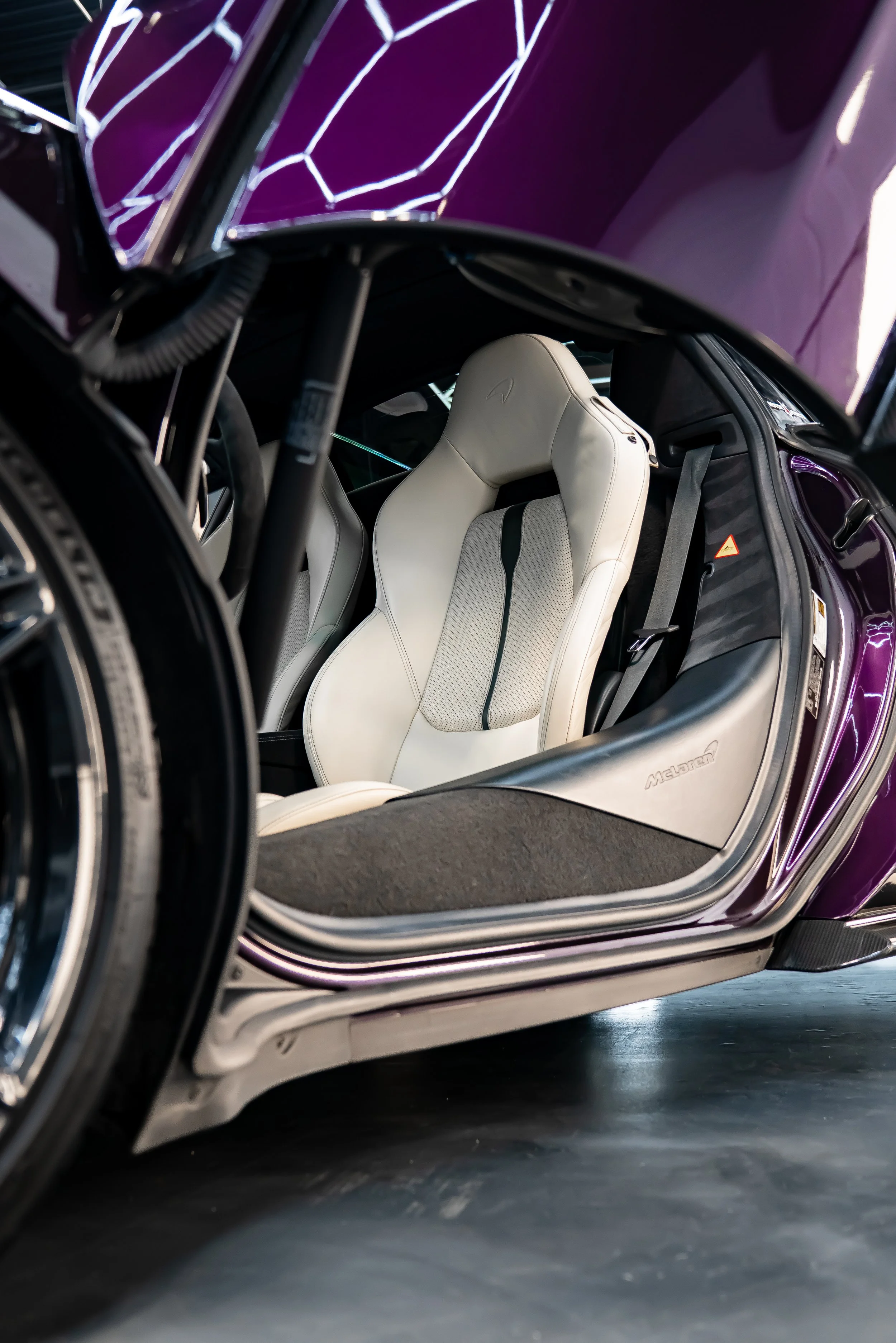 A purple McLaren 570S displayed inside ZAutoCare in Waterloo ON after the results of a polish and ceramic coating.