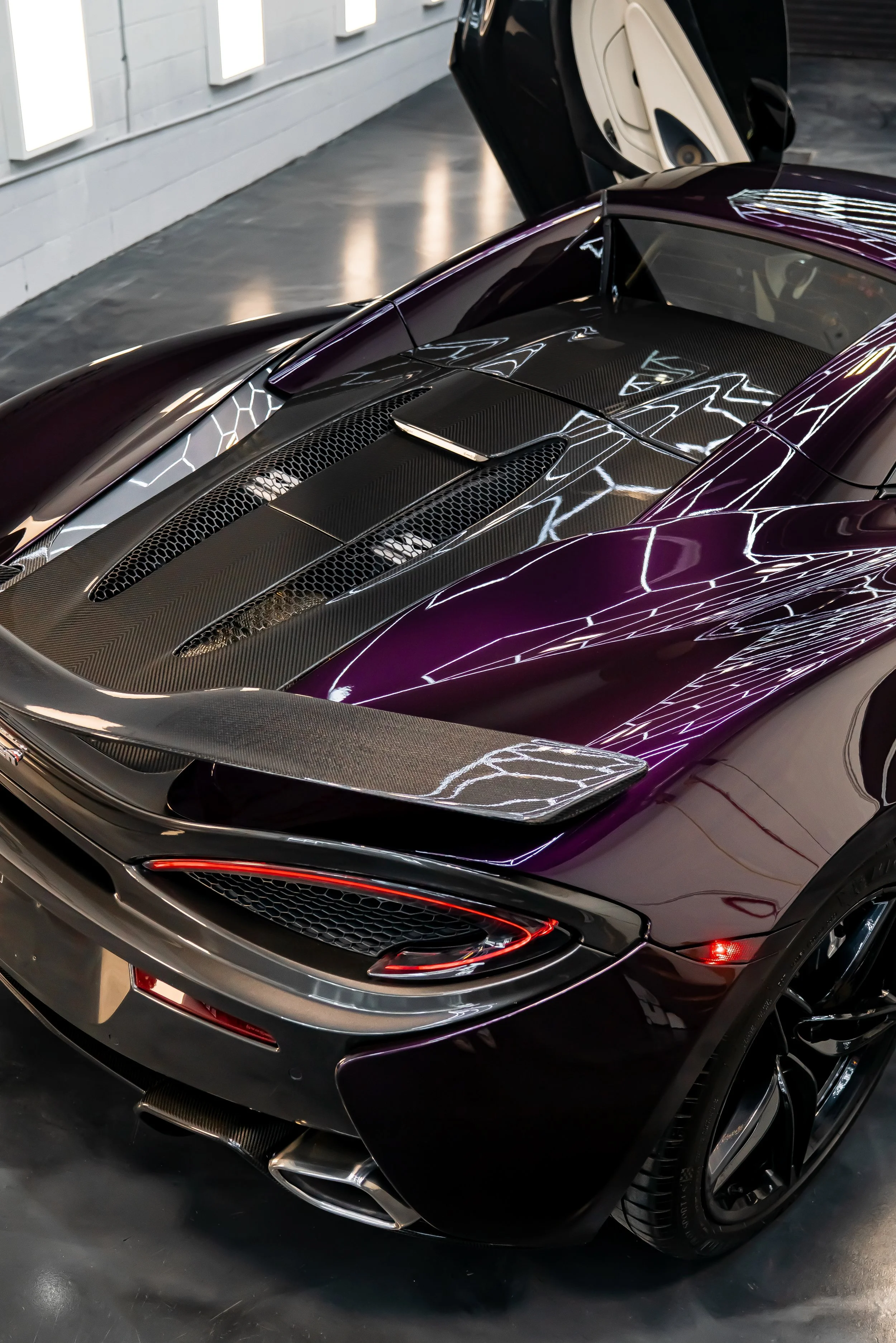 A purple McLaren 570S displayed inside ZAutoCare in Waterloo ON after the results of a polish and ceramic coating.