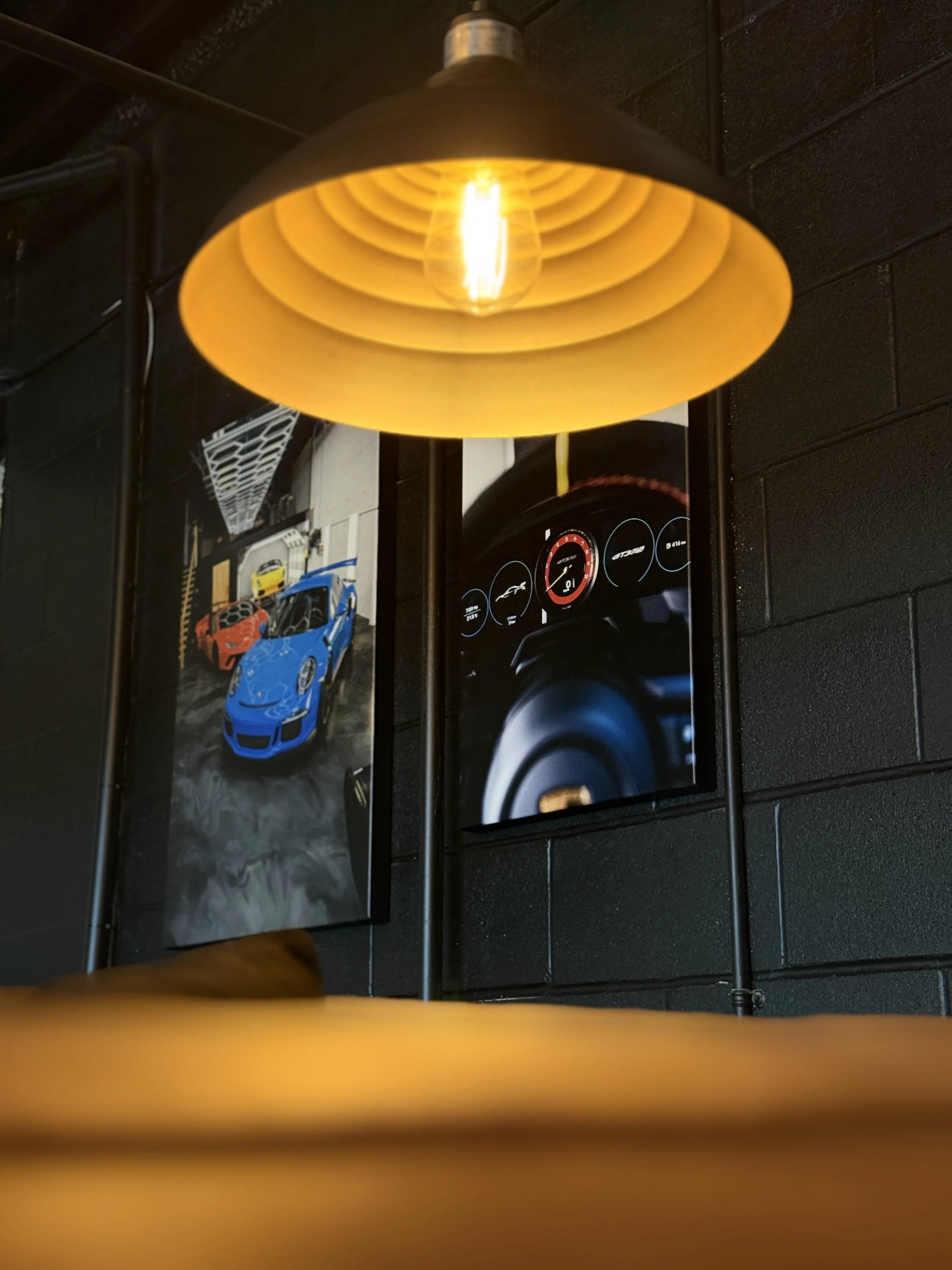 ZAutoCare's lounge from the couch perspective showcasing 2 beautiful car canvas' on the wall.