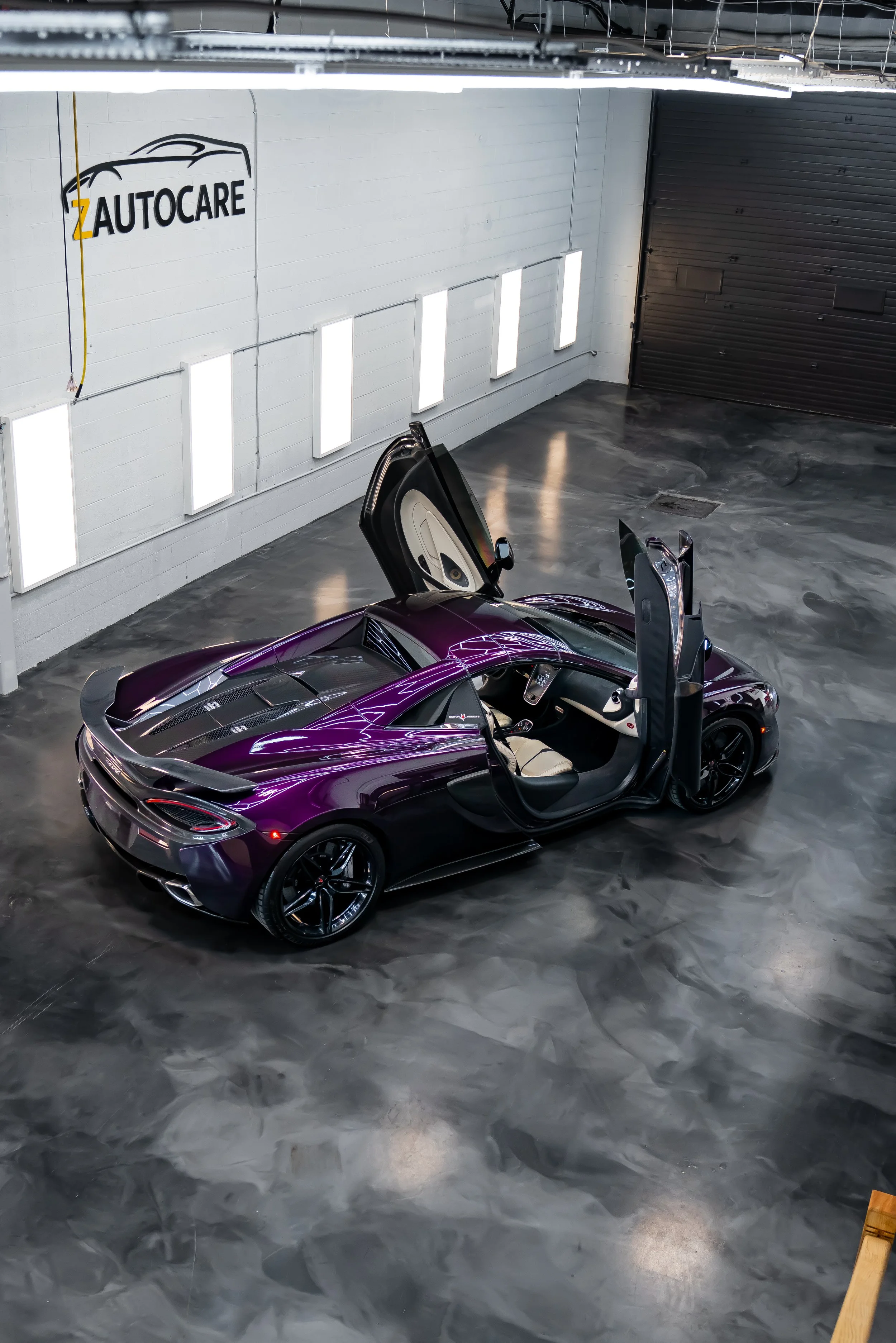 A purple McLaren 570S displayed inside ZAutoCare in Waterloo ON after the results of a polish and ceramic coating.