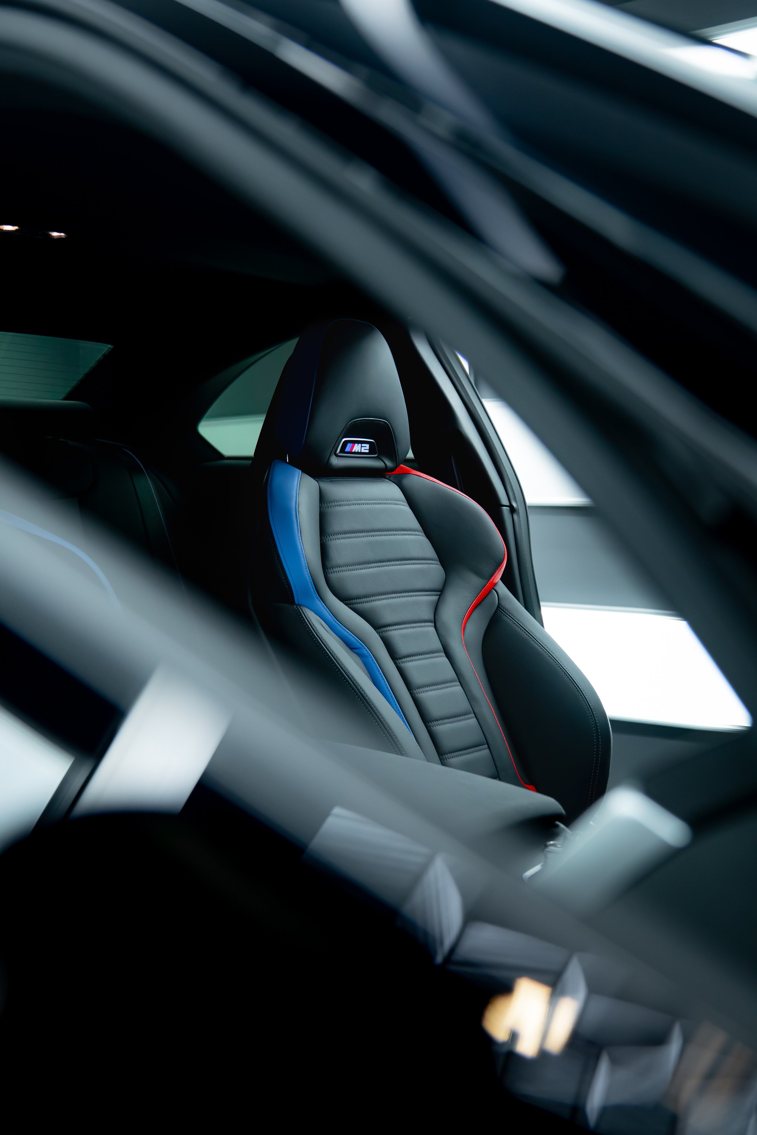 Interior shot of a M2 drivers seat in full black leather.