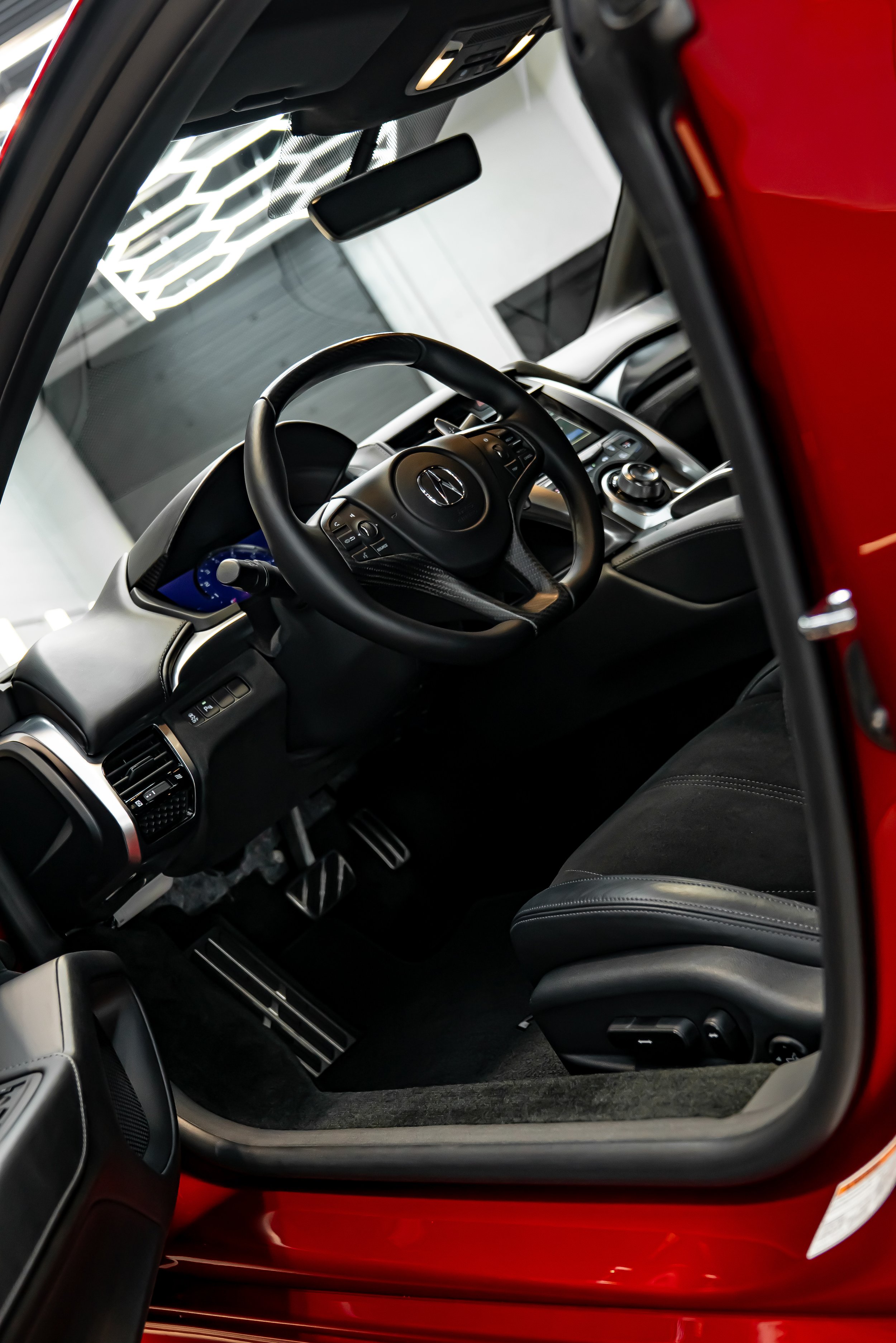 Luxury red Acura NSX supercar receiving professional detailing inside ZAutoCare’s high-end auto detailing studio, featuring glossy paint correction, ceramic coating, PPF and premium vehicle care environment with LED lighting reflections and clean wor