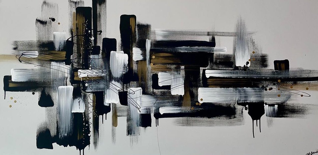 Abstract black, white, and gold brushstrokes and splatters on a white background