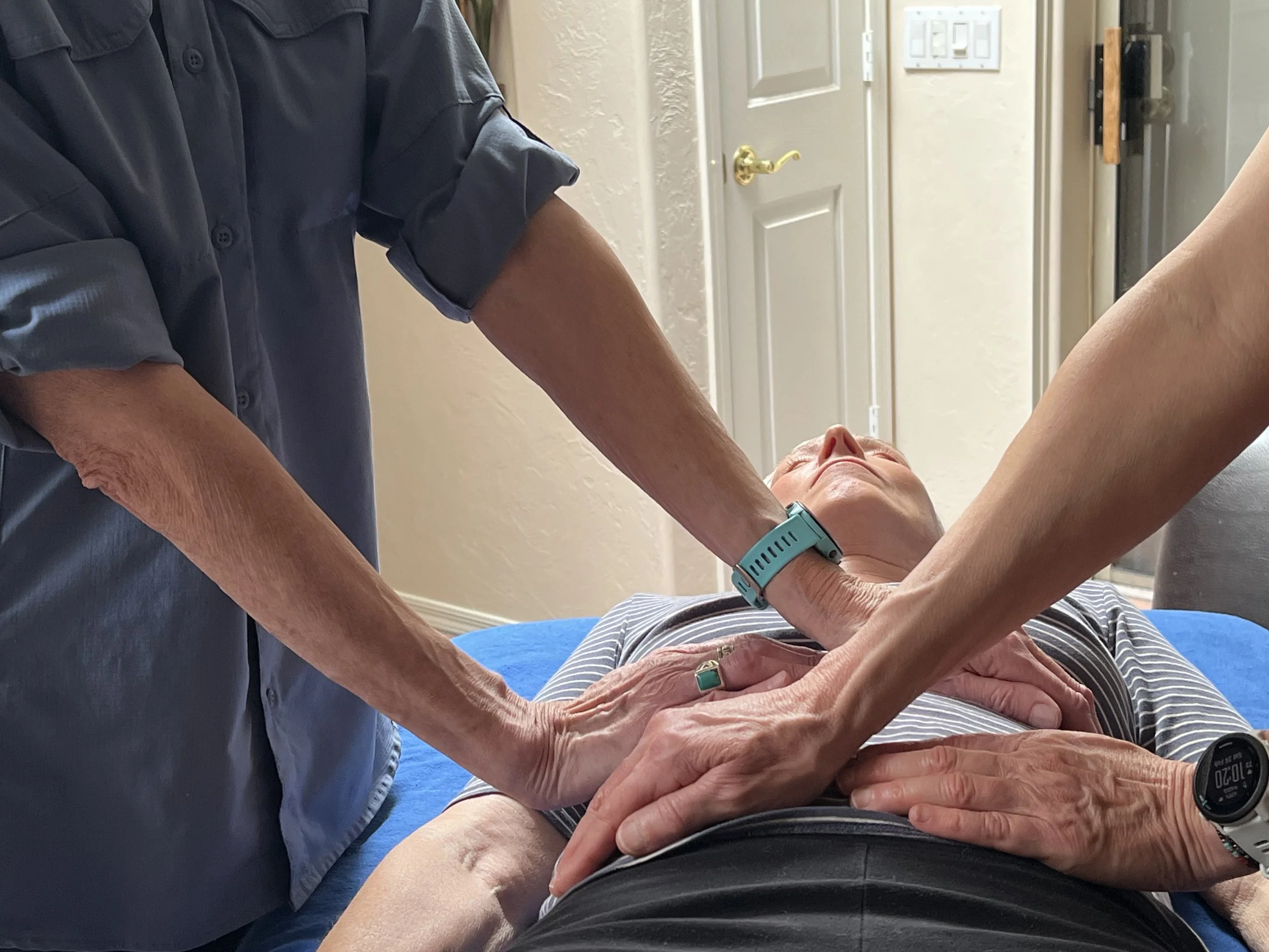 Both Reiki Masters doing Reiki on a client to amplify energy