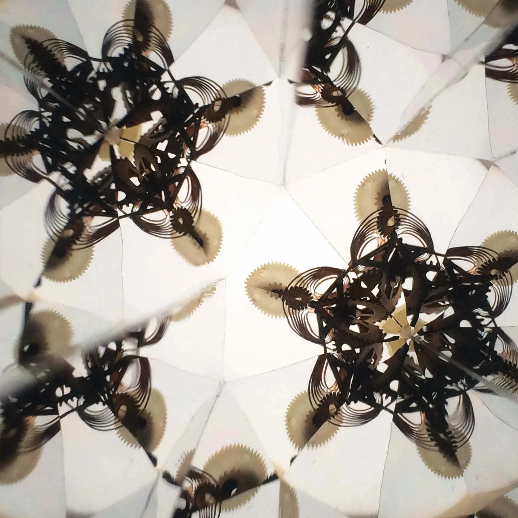 Abstract mechanical symmetry created with metal cogs and gear wheels.