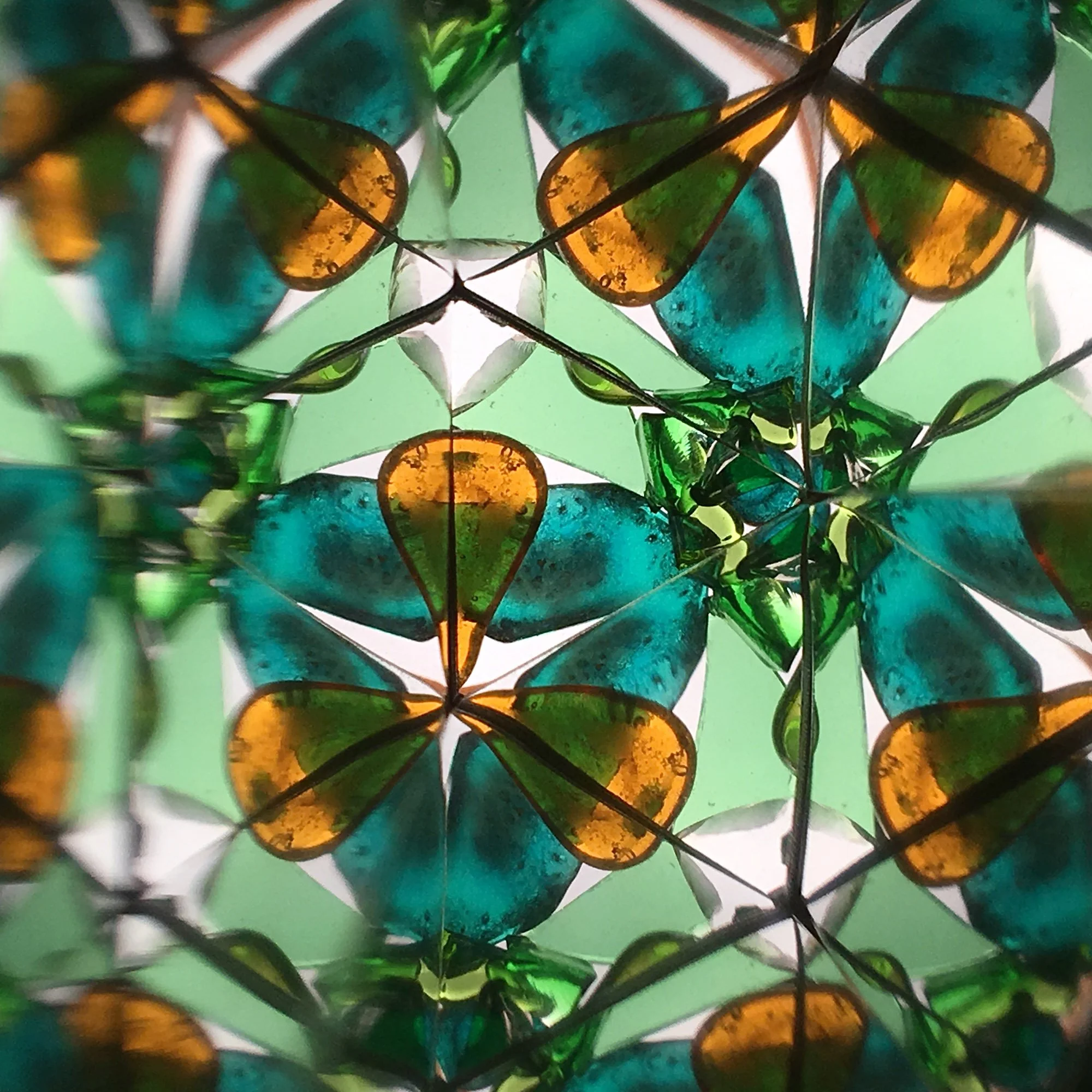 Handmade Lithuanian forest kaleidoscope with natural hazel bark and recycled glass.