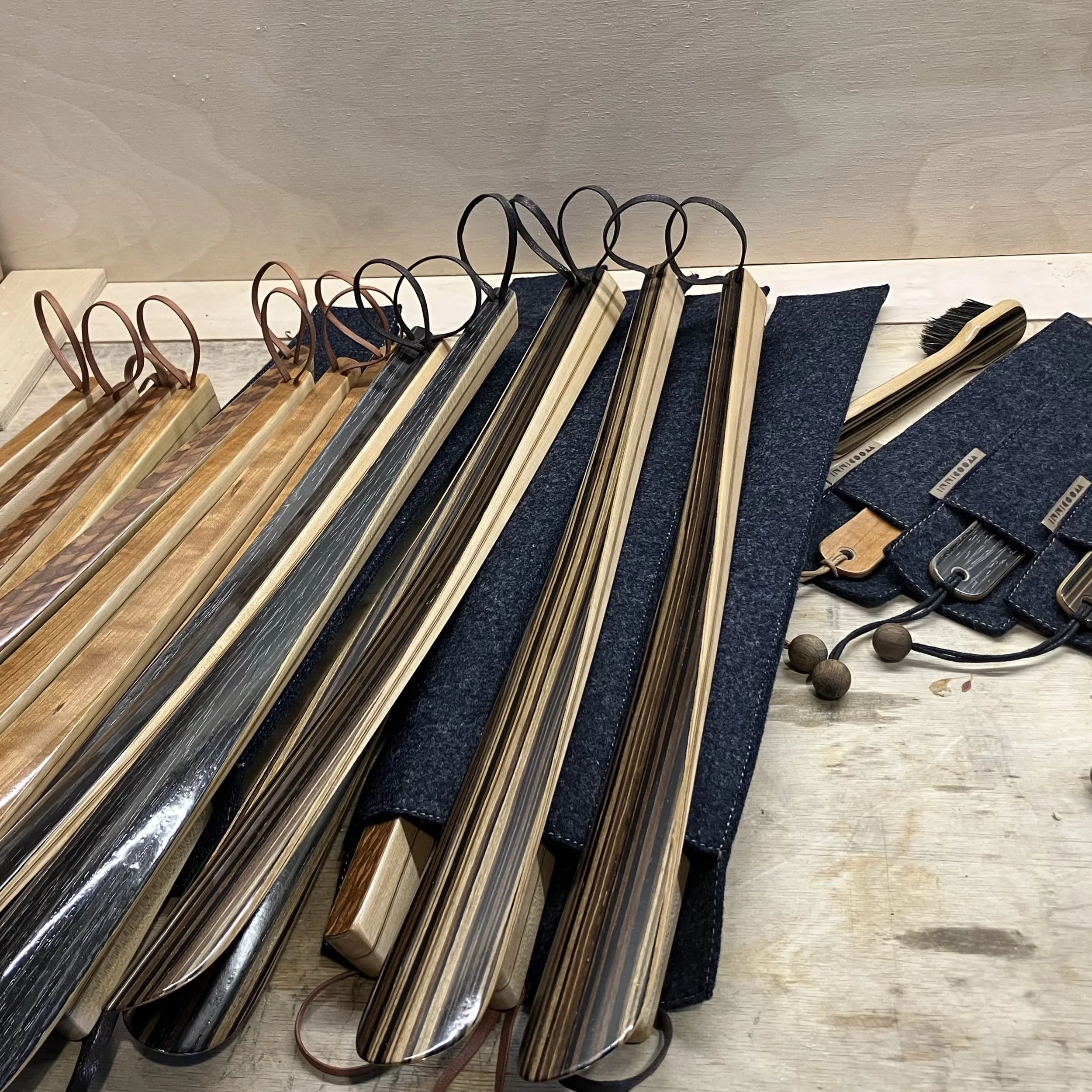  A complete collection of premium handcrafted long shoehorns with leather straps and protective felt storage pouches. 