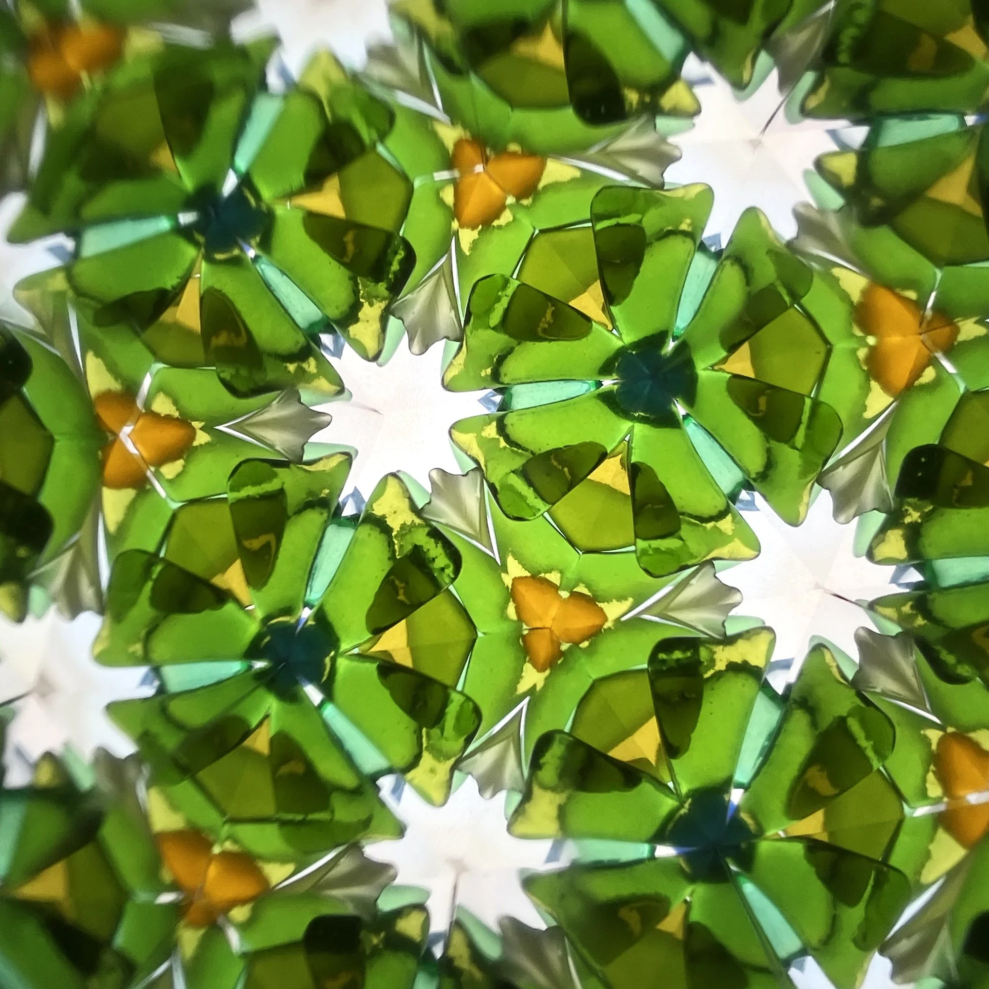  Dense geometric pattern of lush green tones and crystalline shapes inspired by Irish nature. 