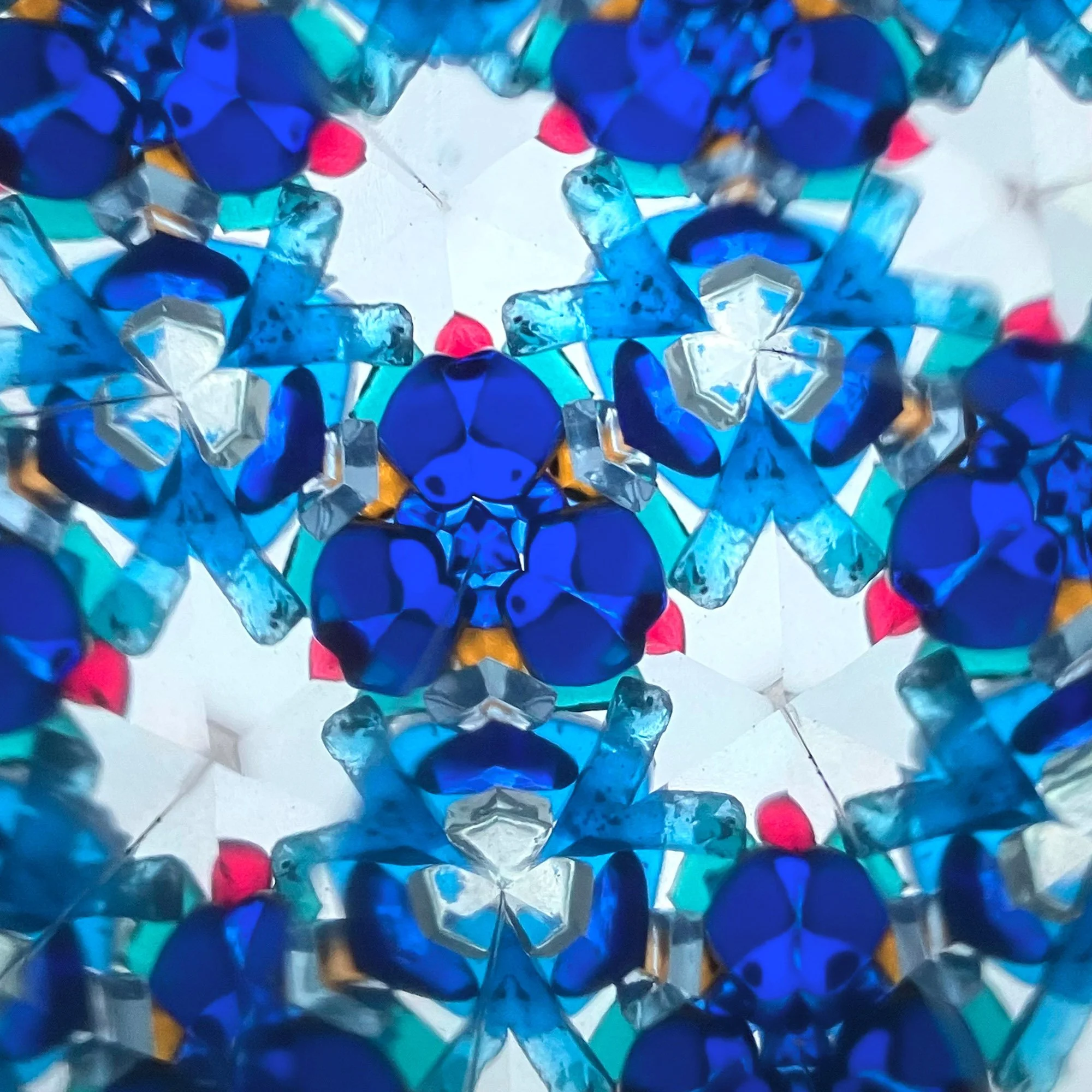  Intricate blue and turquoise kaleidoscope pattern forming a star-shaped mandala, inspired by Islamic geometric design and tiled symmetry. 