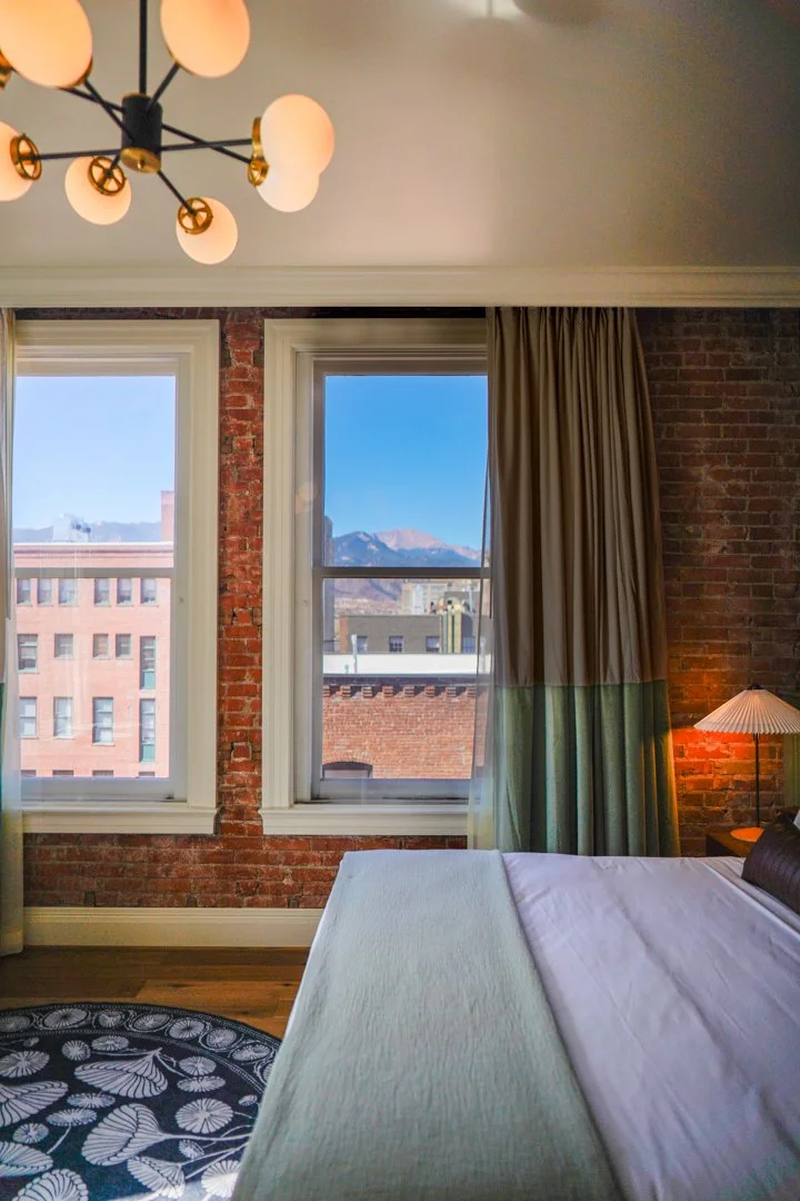 Interior of a hotel room looking out to the mountains