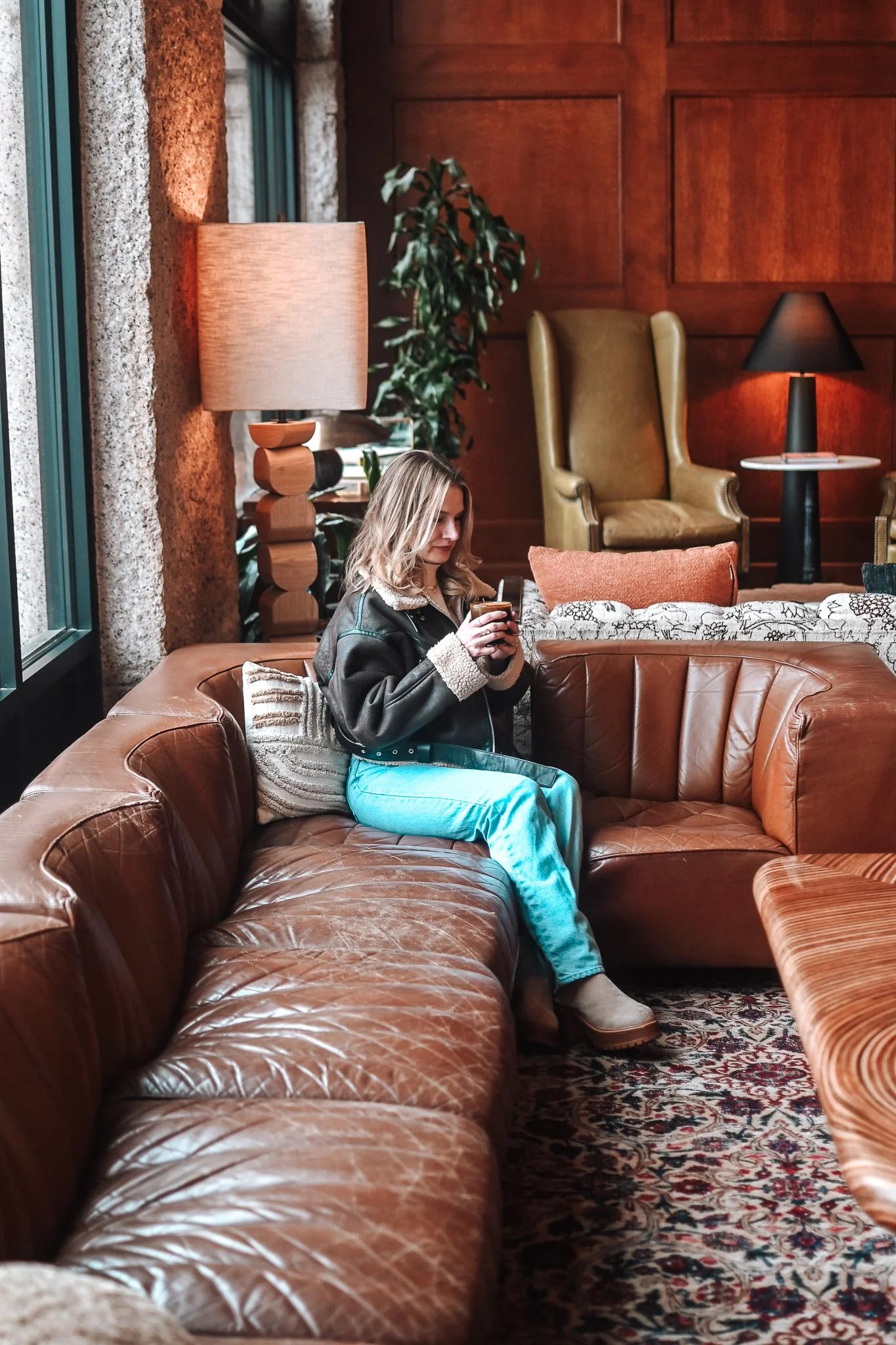 Hotel lobby with a brown leather couch and warm lighting