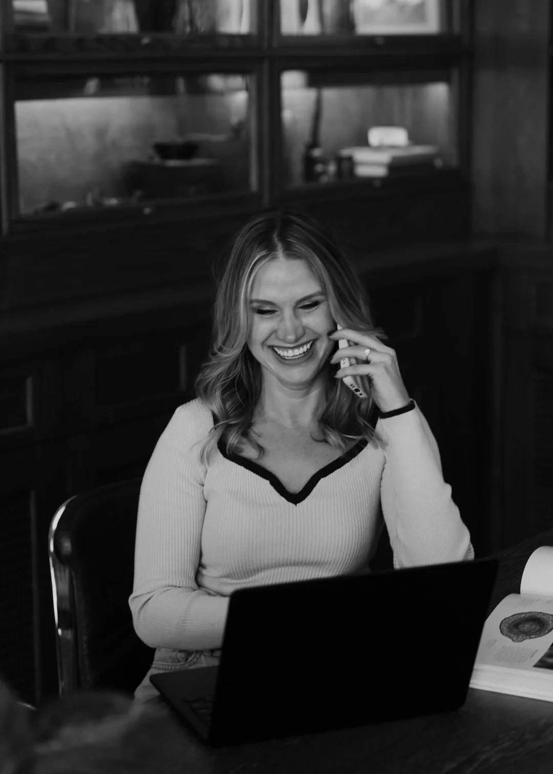 A black and white photo of Bonnie smiling on the phone