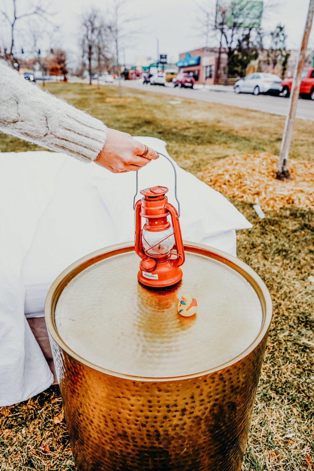 A woman grasps the top of a red lantern