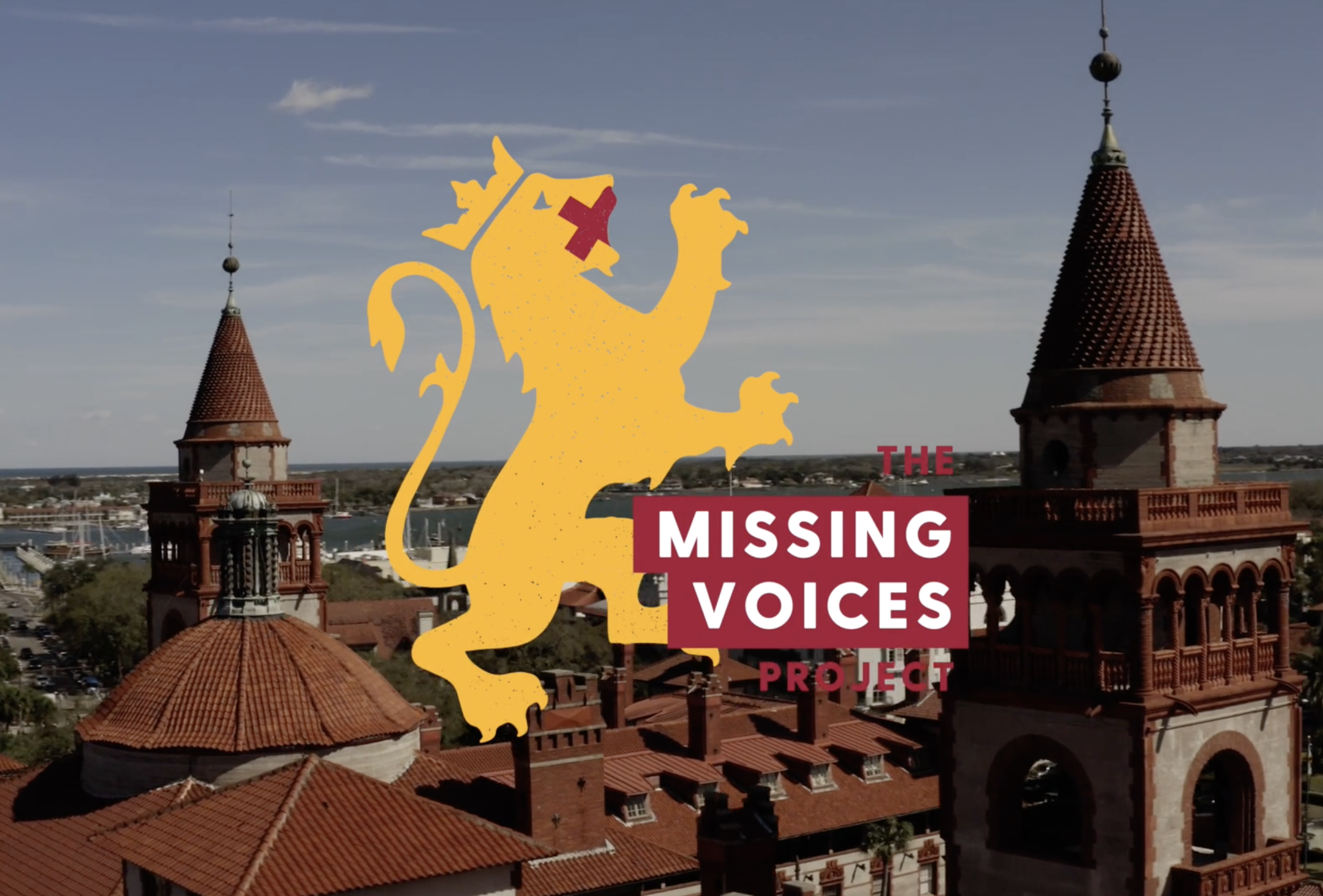 A cityscape with historic red-brick buildings and towers under a blue sky, featuring a logo with a yellow lion and the text 'The Missing Voices Project' in white and red.