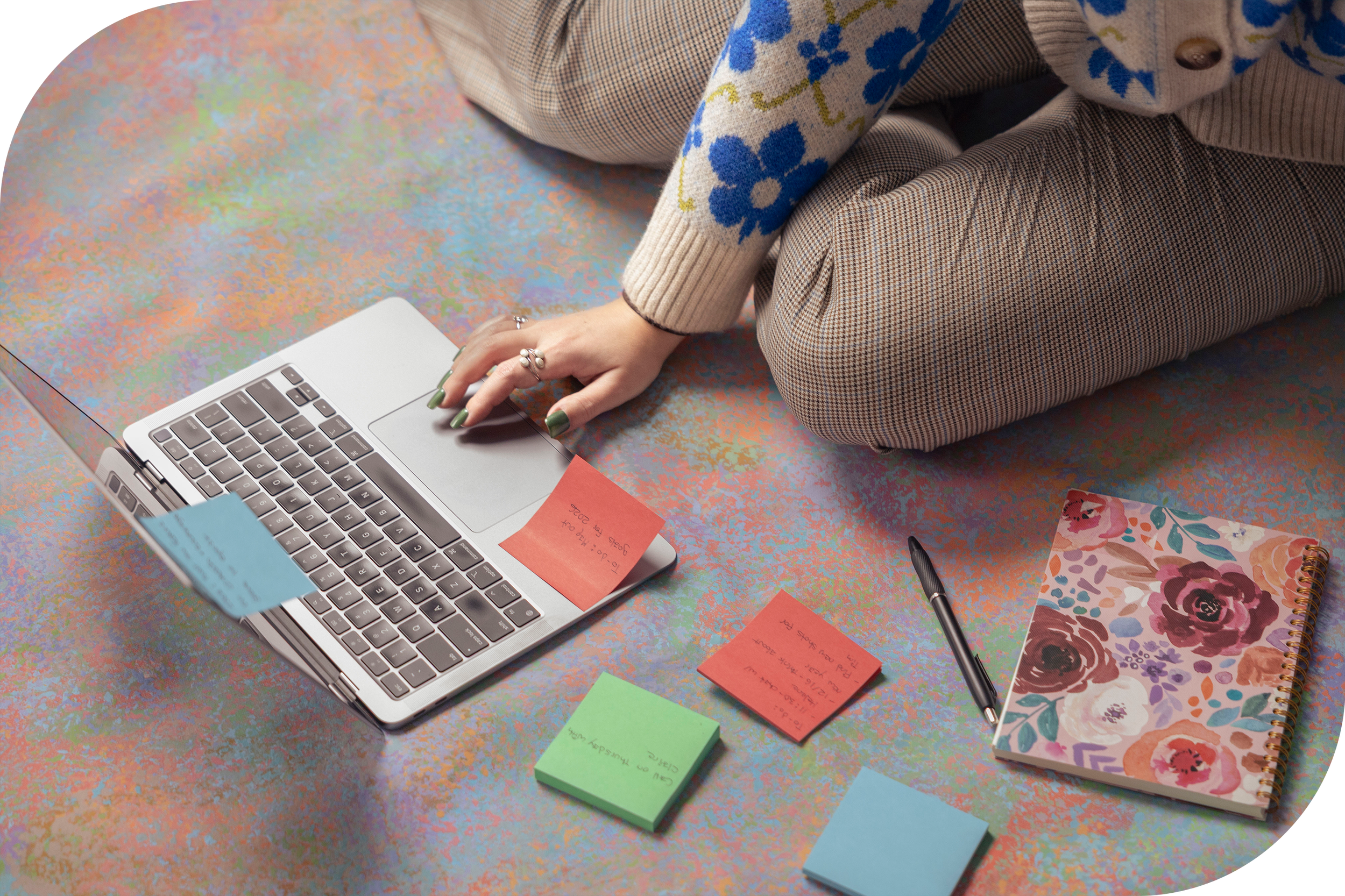 A picture of Olivia's hand at her laptop computer surrounded by post-its.
