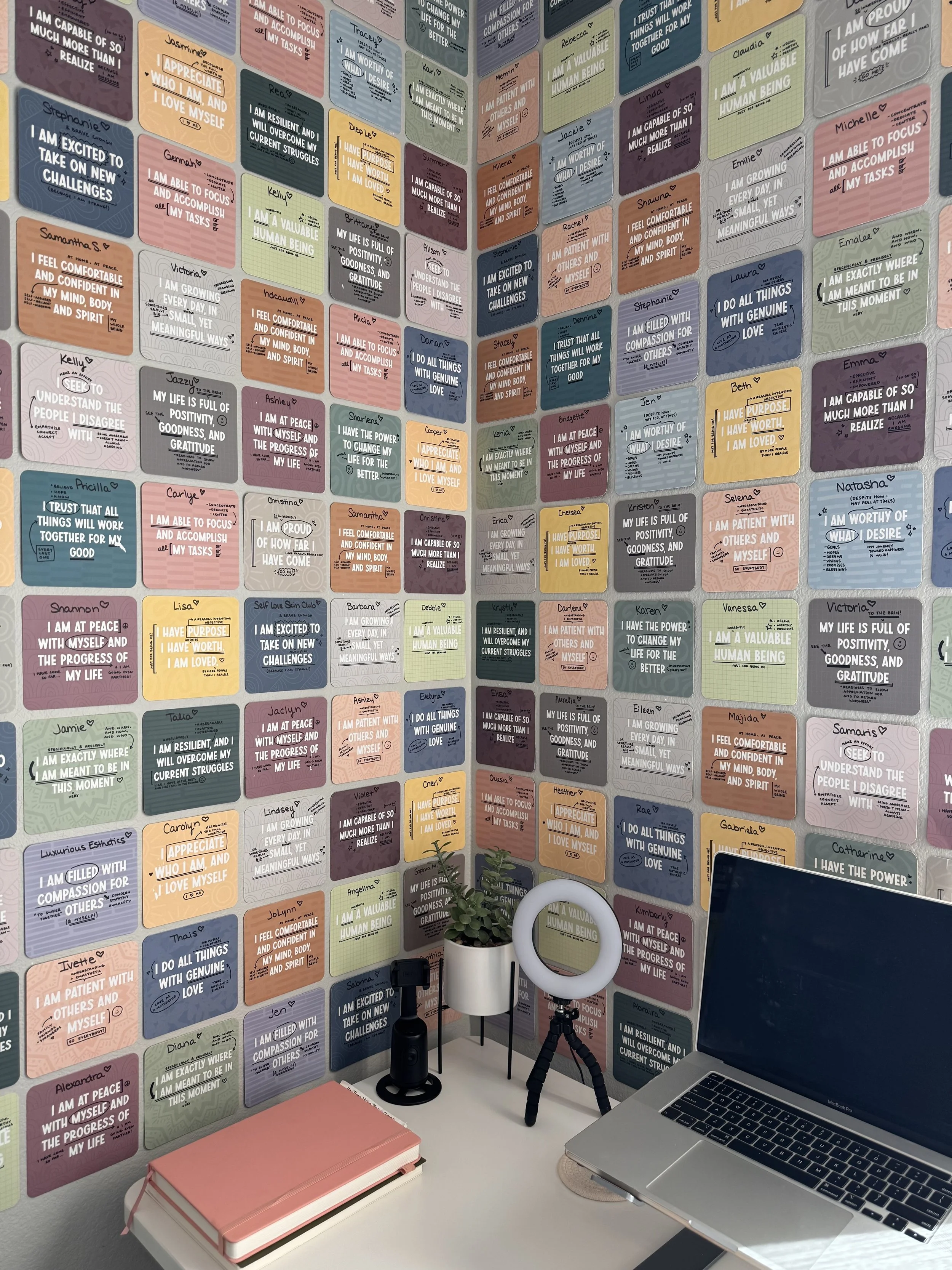 The Glow Sis Social affirmation wall covered in handwritten cards with the names of estheticians Shaylee serves