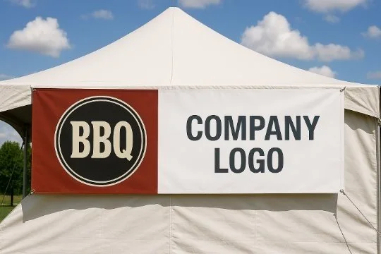 A large outdoor event tent with a banner reading "BBQ" and "Company Logo" on the front.