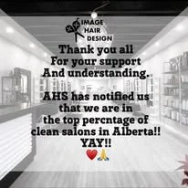 Black and white interior of a hair salon with a sign thanking supporters and announcing high placement in Alberta's clean salons, with the salon's logo at the top. Okotoks, support, love, professionals, small business,