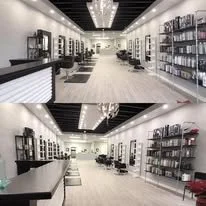 Interior of a modern hair salon with styling stations, mirrors, and chairs.