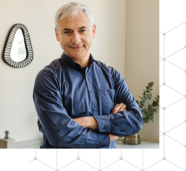 Photo of Dr. Albert Fuchs wearing a blue shirt and crossing his arms.