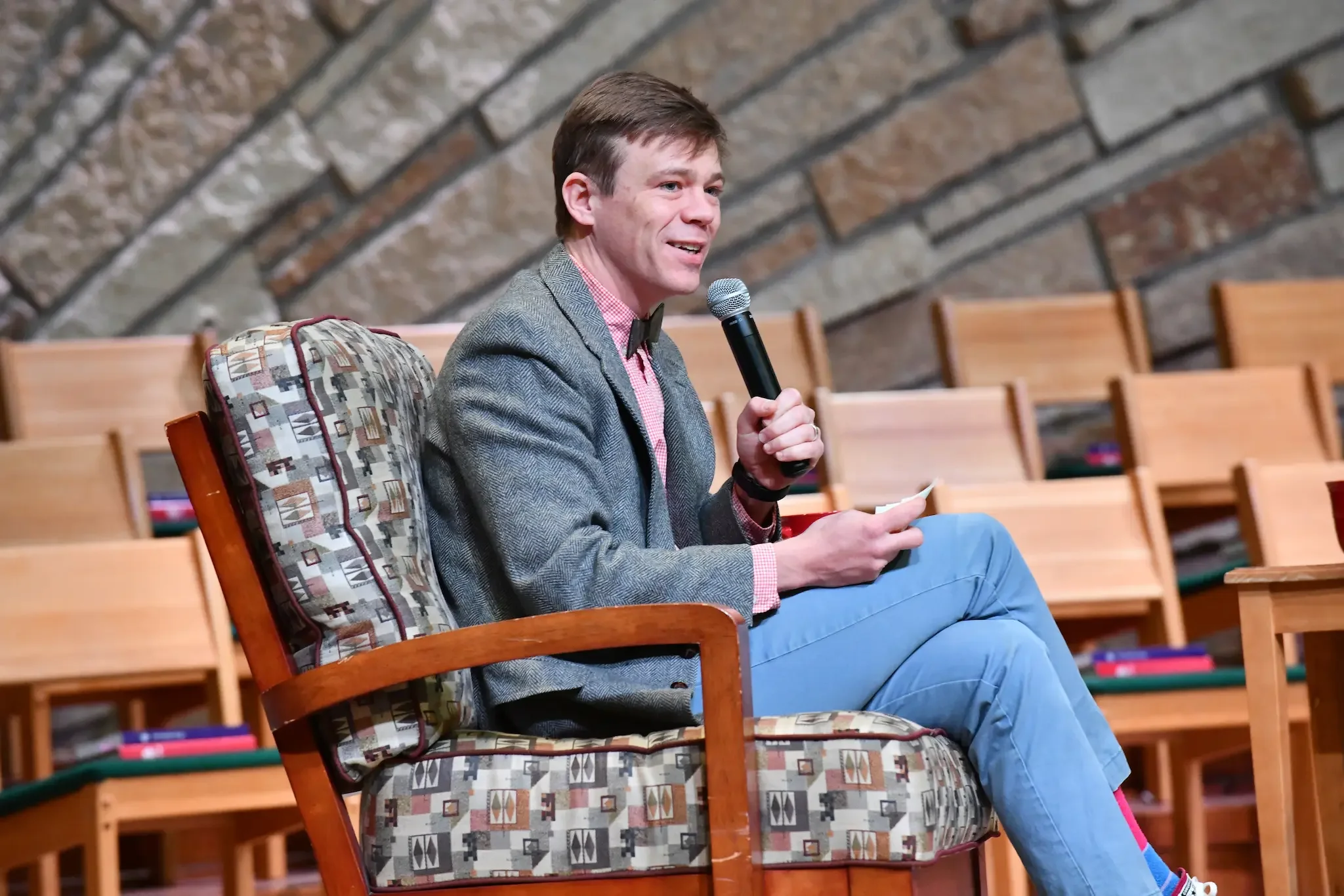 Person speaking with a microphone.