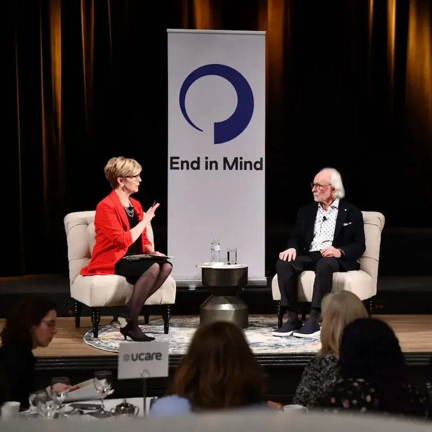 Two people sitting on a stage at and End in Mind event.