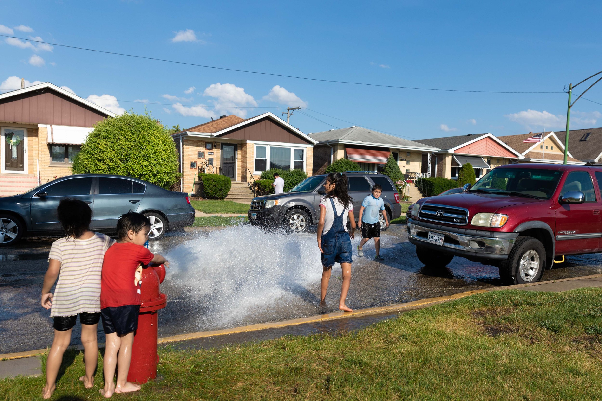 Children run through a spray of water from a fire hydrant in the Archer Heights neighborhood during the summer heatwave. This photo is part of the Columbia Chronicle’s “77 Community Areas” project, documenting Chicago ahead of America’s 250th birthda
