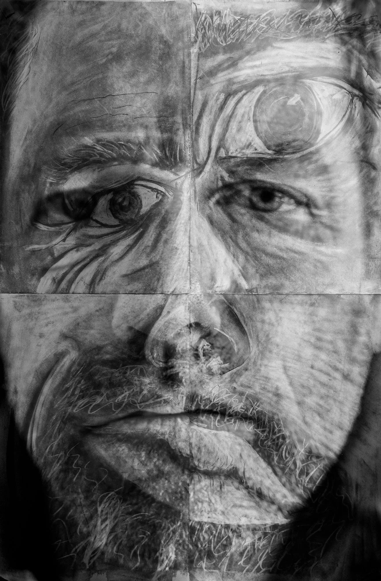 A black and white portrait drawing of a person's face showing the eyes, nose, and lips with detailed shading and textured strokes.